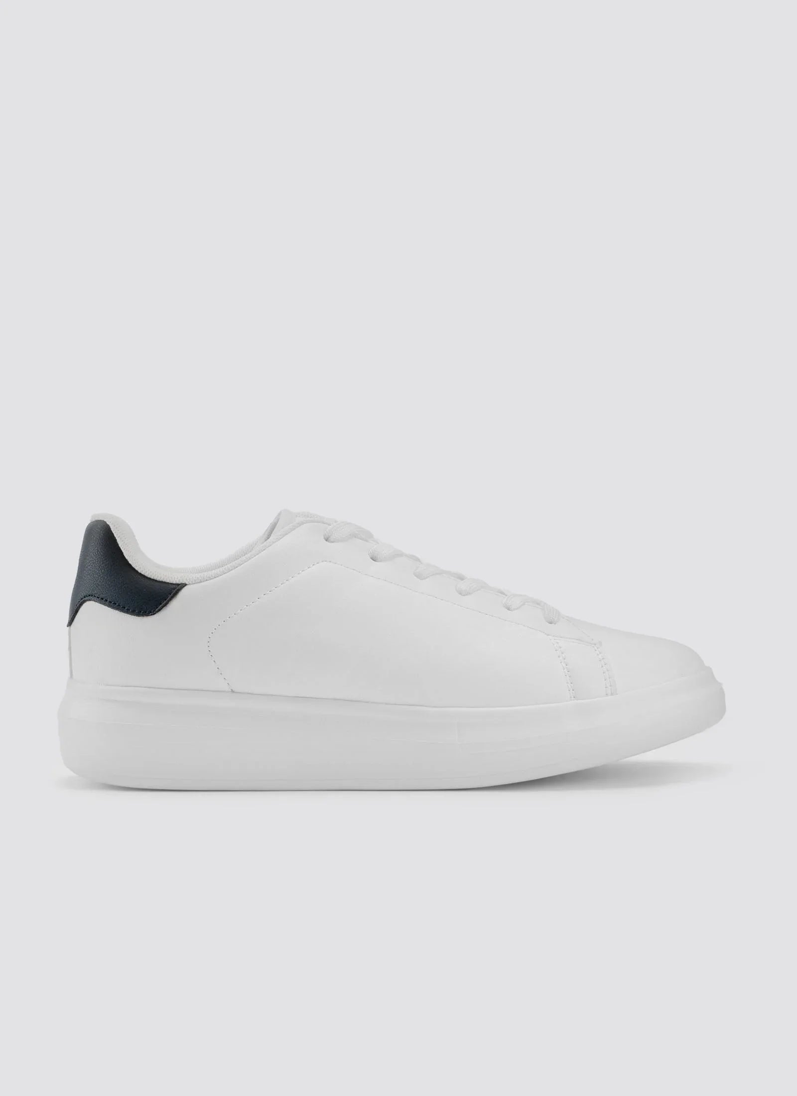 White leather sneaker with black heel accent, minimal lace-up design, side view on plain background #color_white-black
