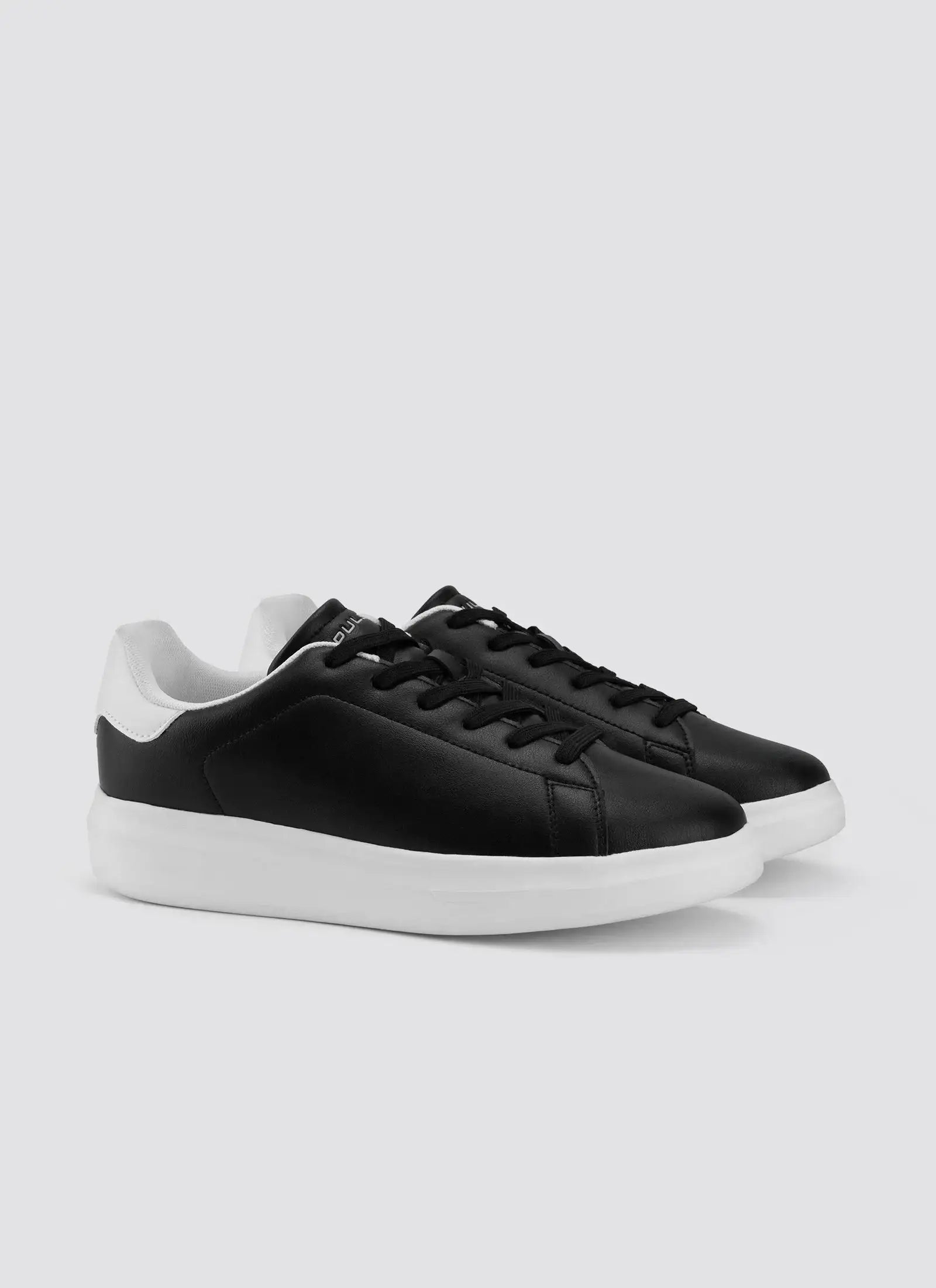 Black and white low-top sneakers with white soles, stylish men's casual footwear