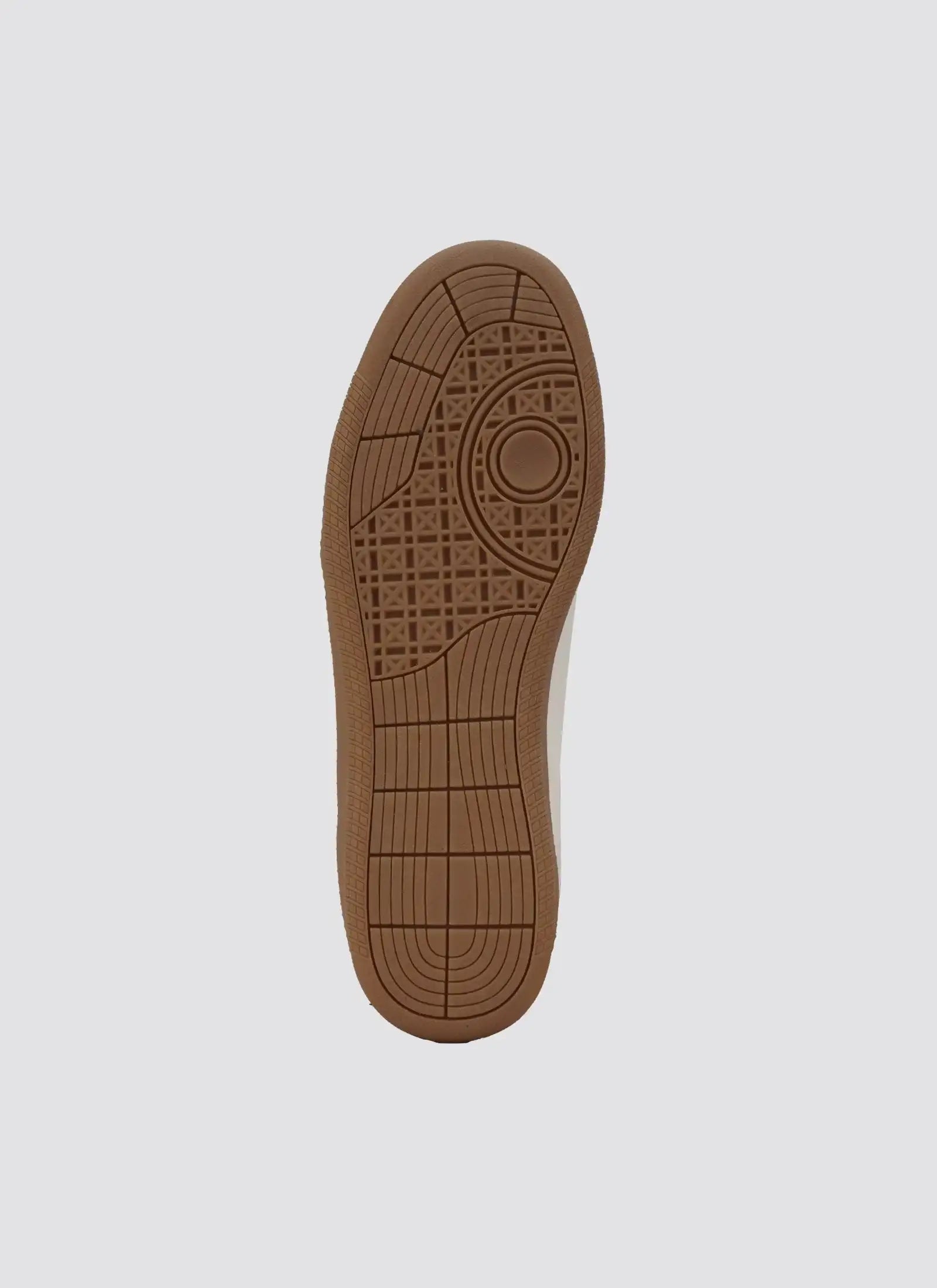 Close-up of brown rubber sole with textured grip pattern on men's sneaker