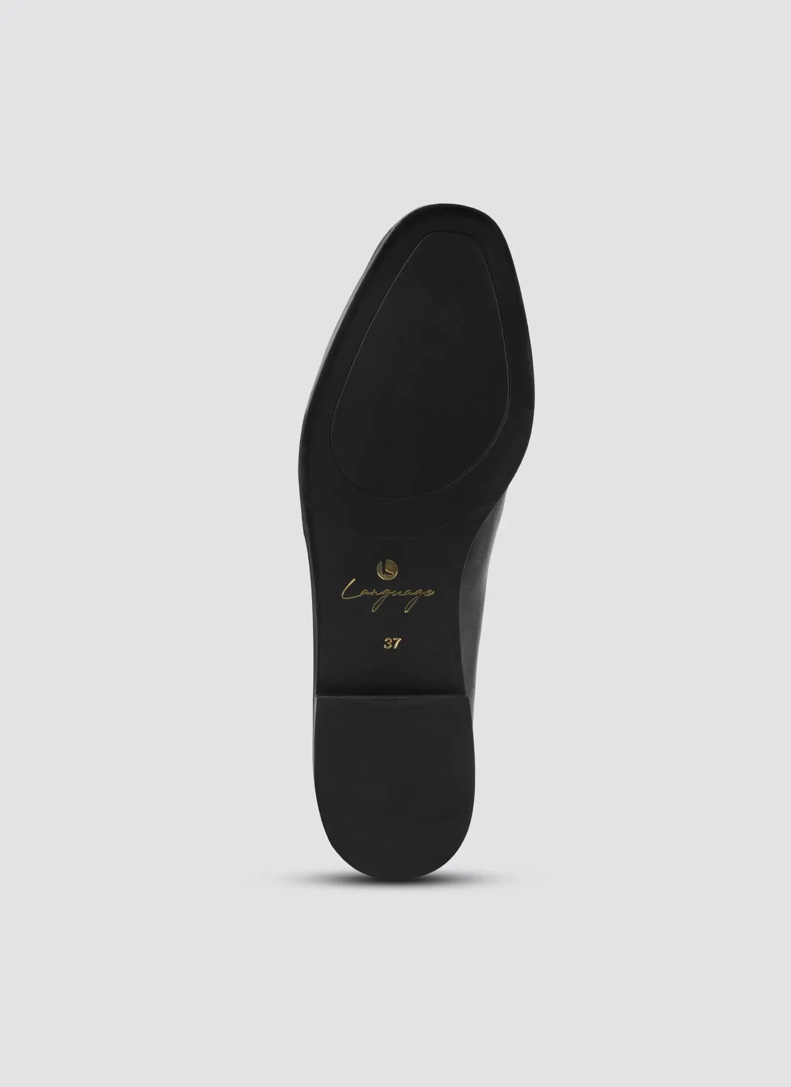 Black shoe sole with 'Camper' branding on a light gray background