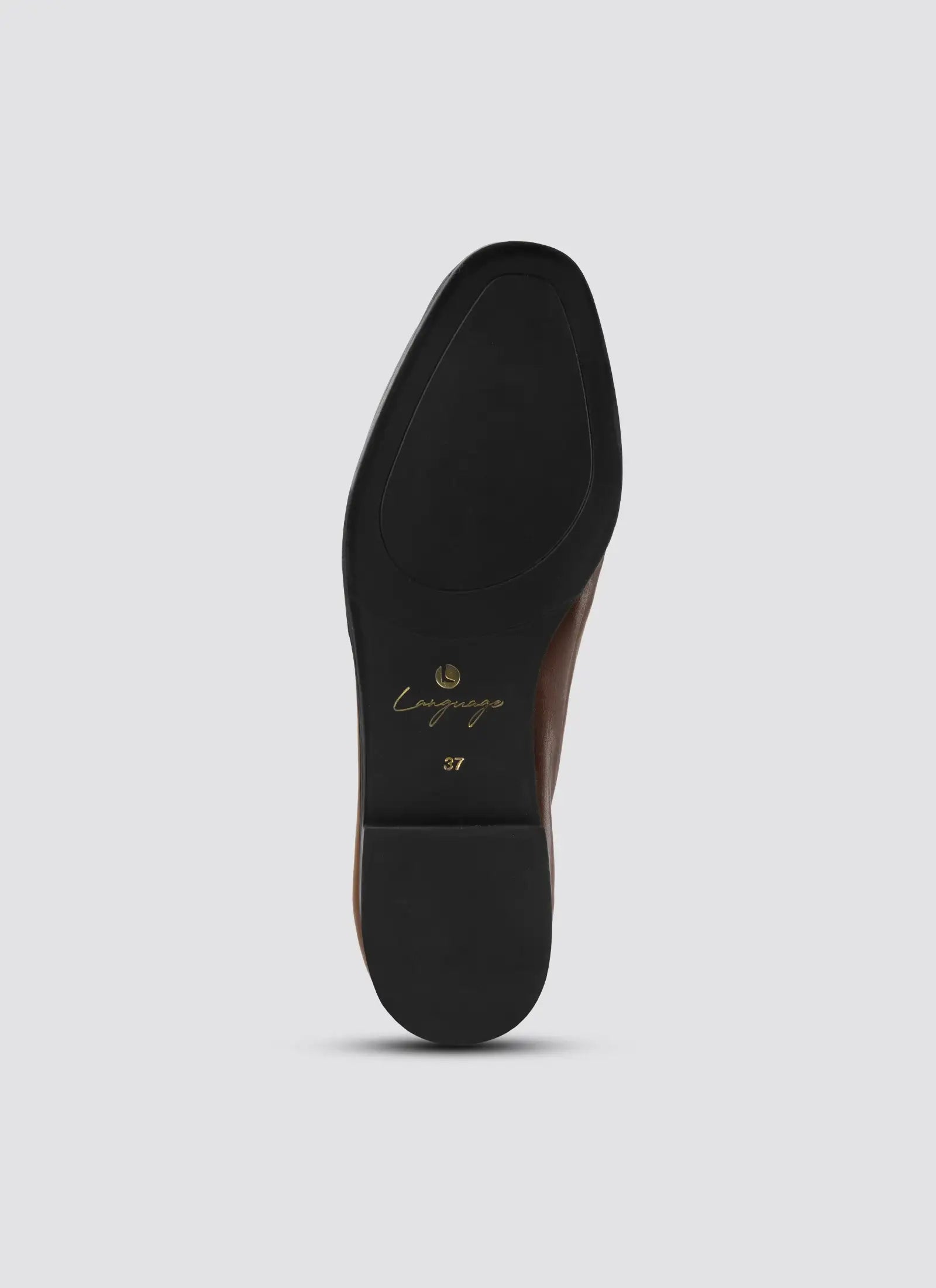 Close-up of a shoe sole with 'Camper' branding on a light gray background