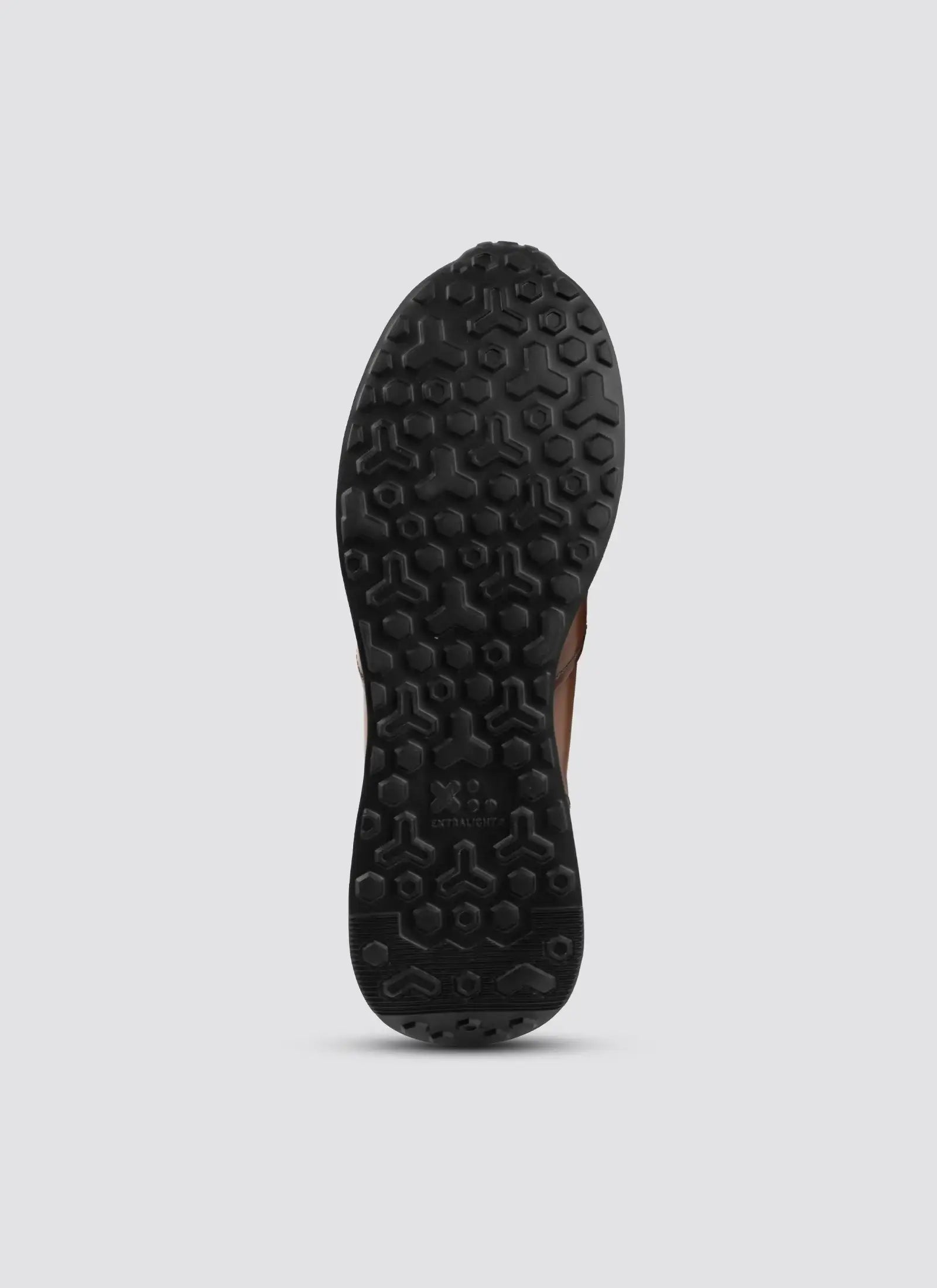 Black textured rubber shoe sole with geometric tread pattern for men’s footwear