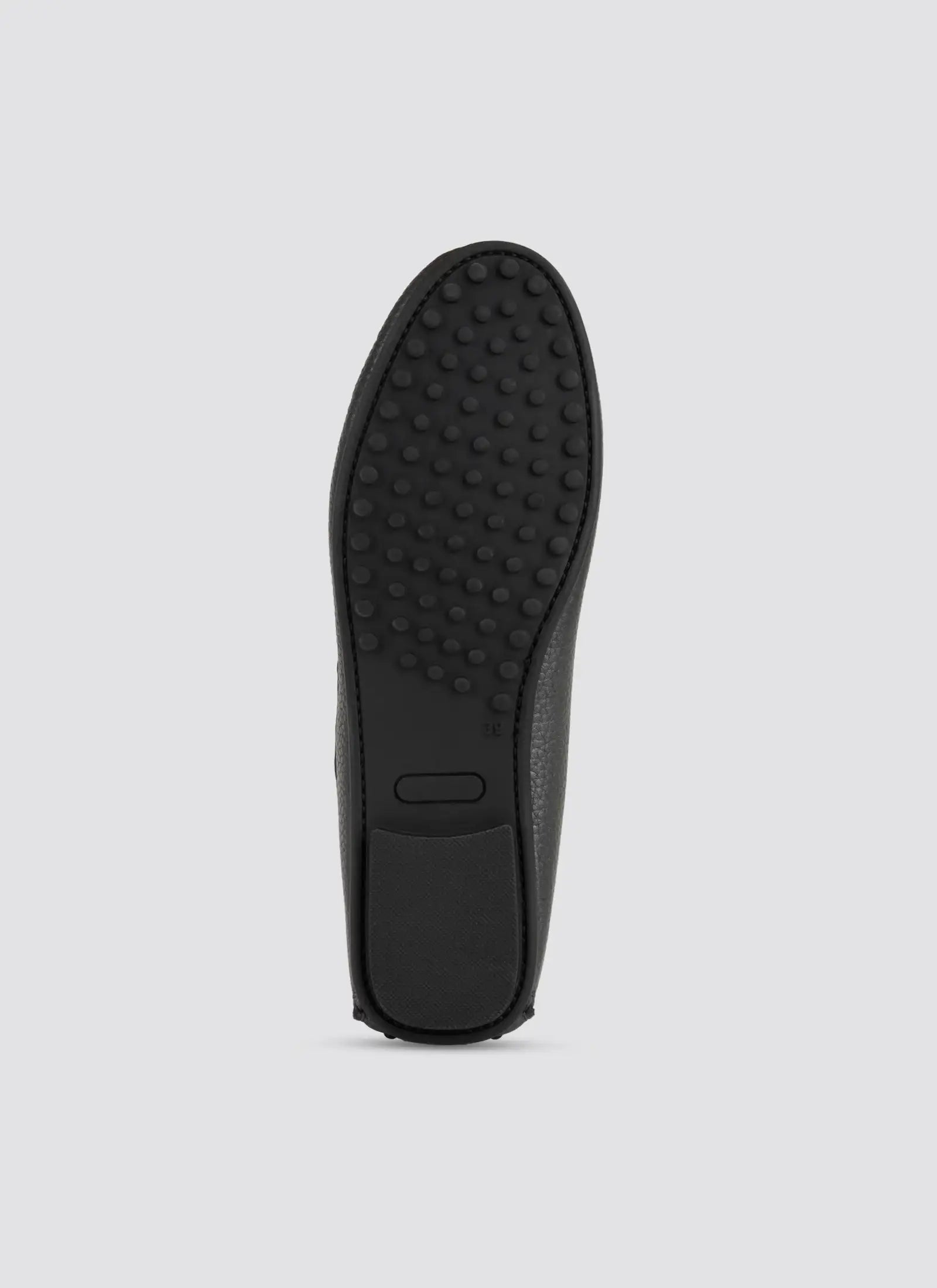 Black shoe sole on a light gray background