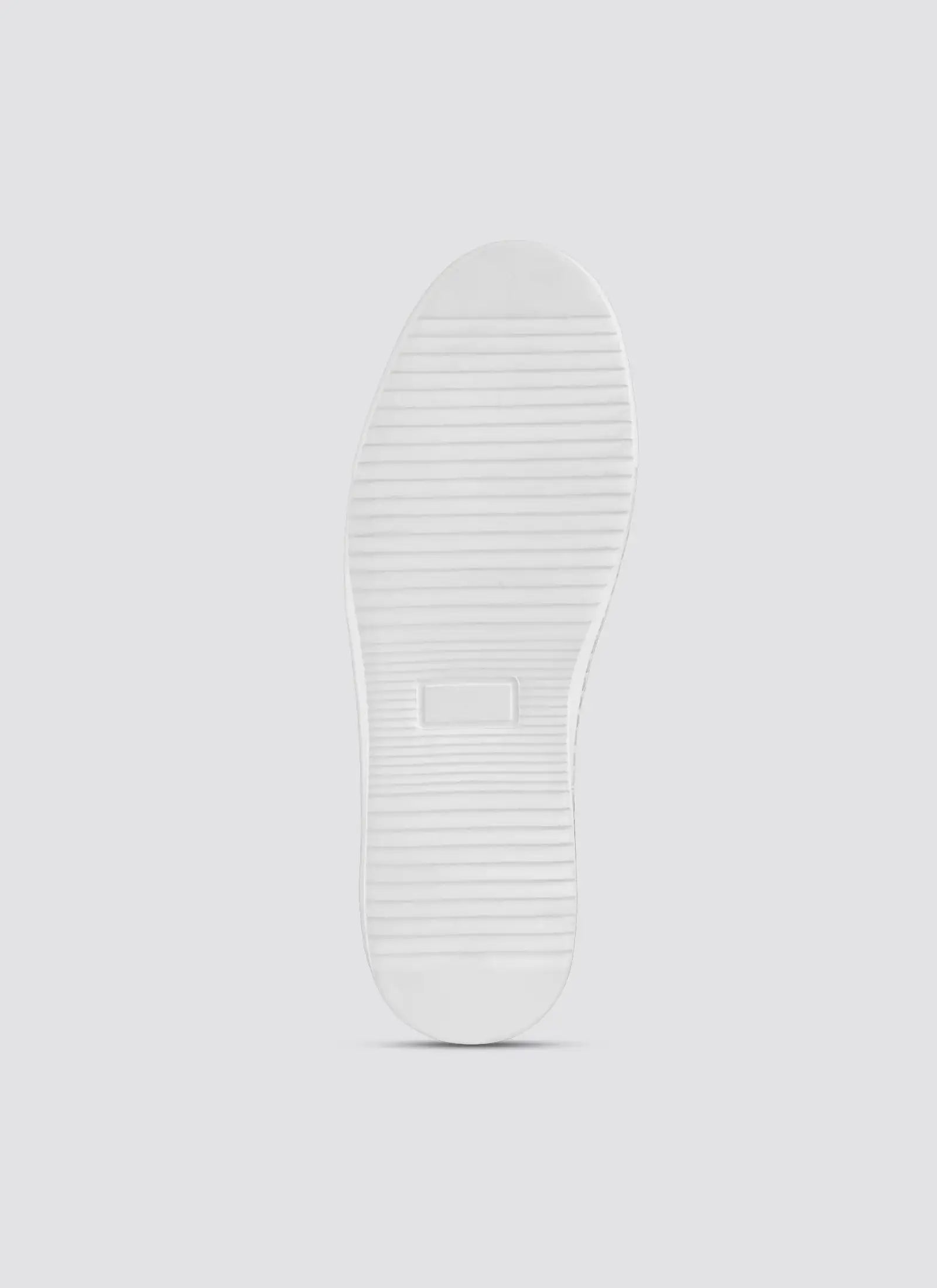 Close-up of a white sneaker sole on a light gray background