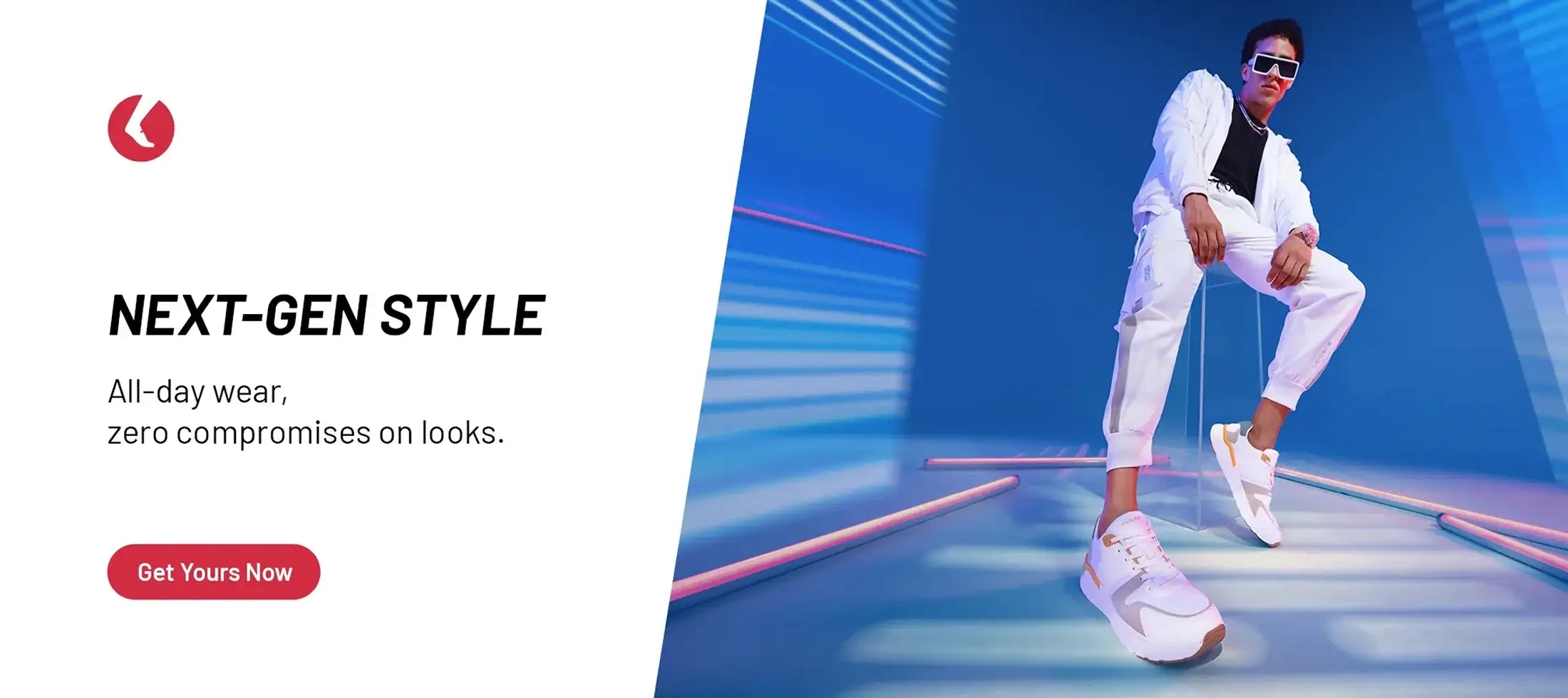 Man in stylish white sneakers and tracksuit, modern blue-lit studio, footwear fashion