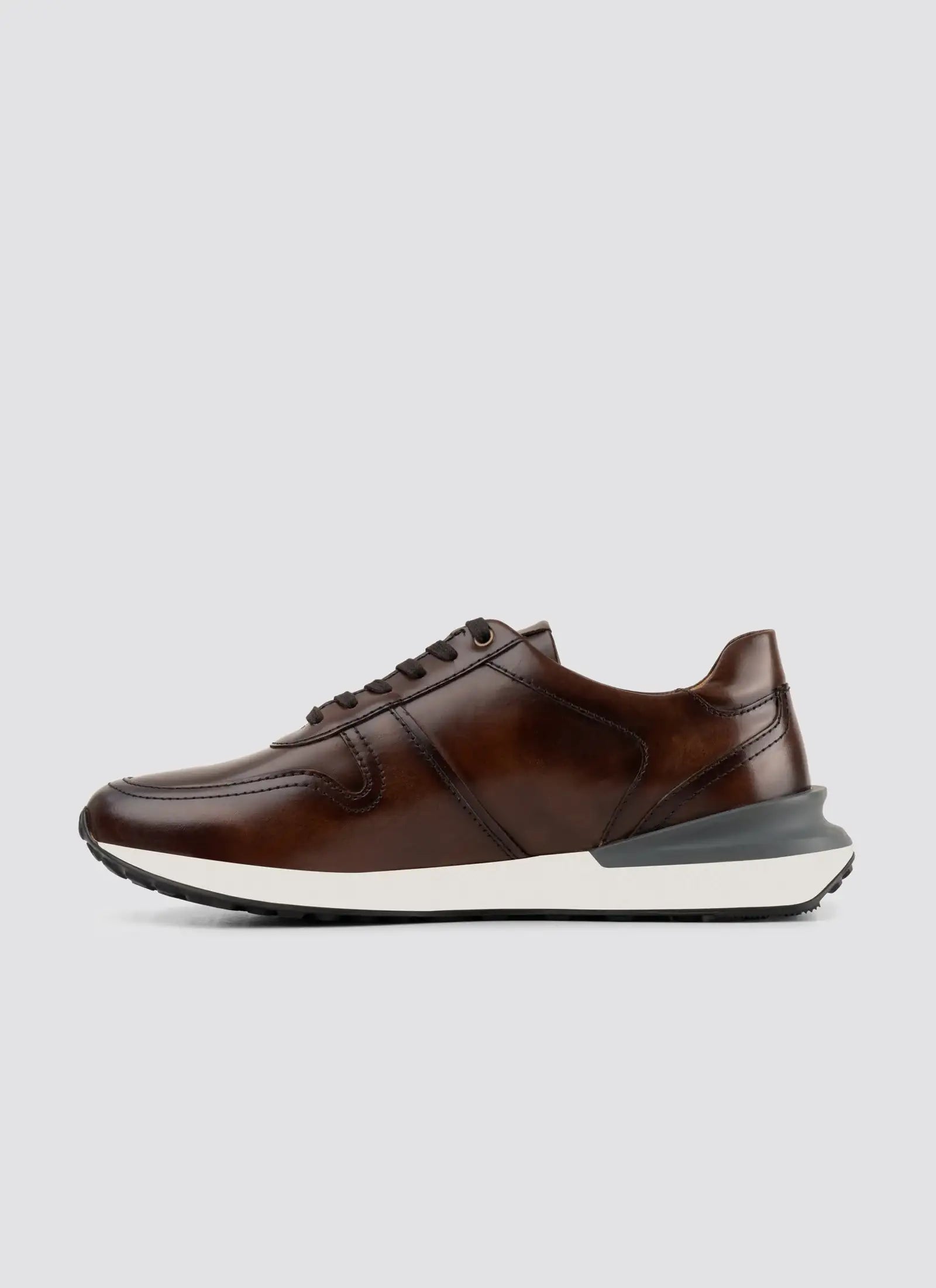 Brown leather casual sneaker with white sole, men’s footwear on plain background