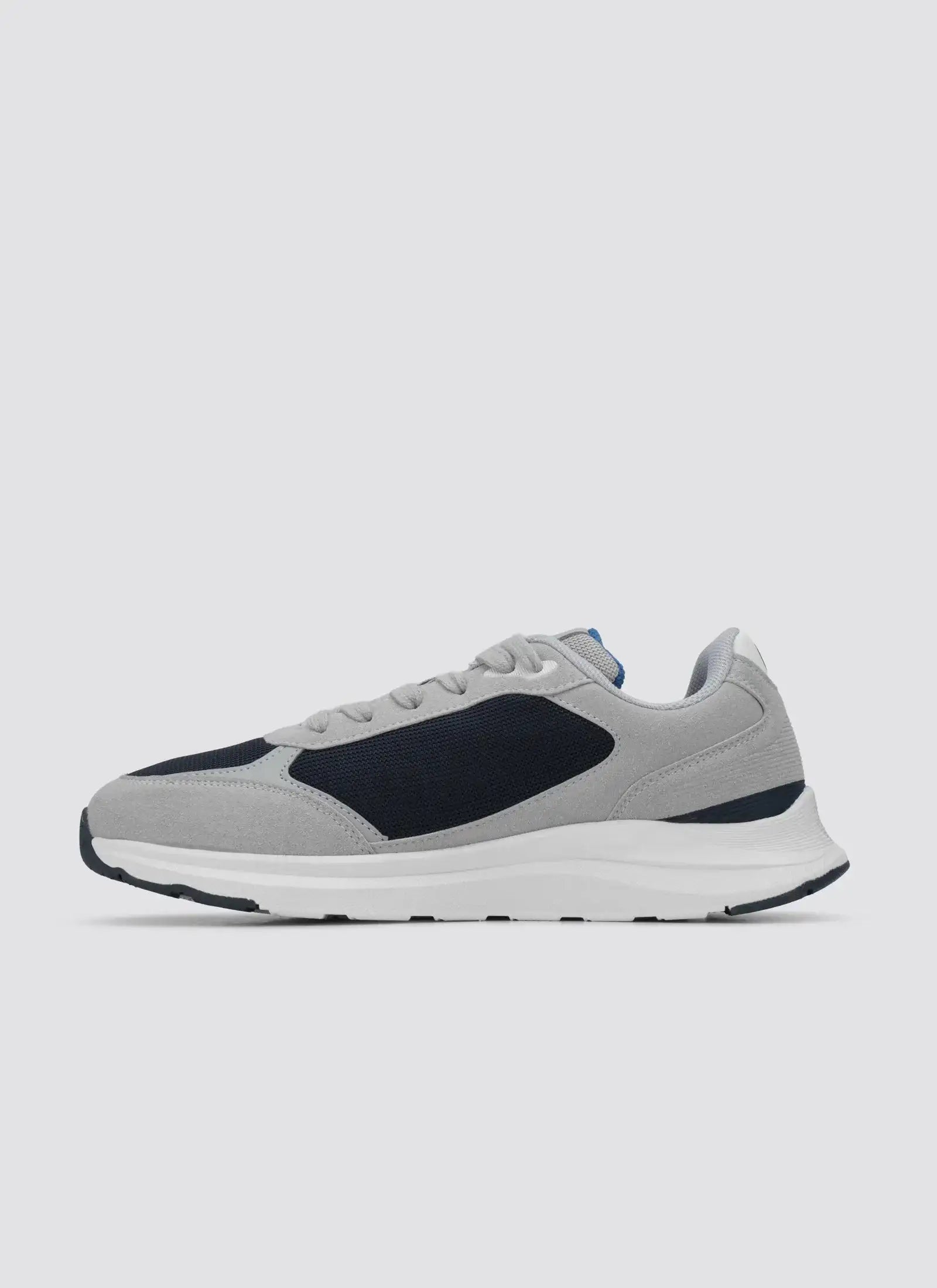 Grey and navy blue casual sneaker with white sole, side profile on plain background