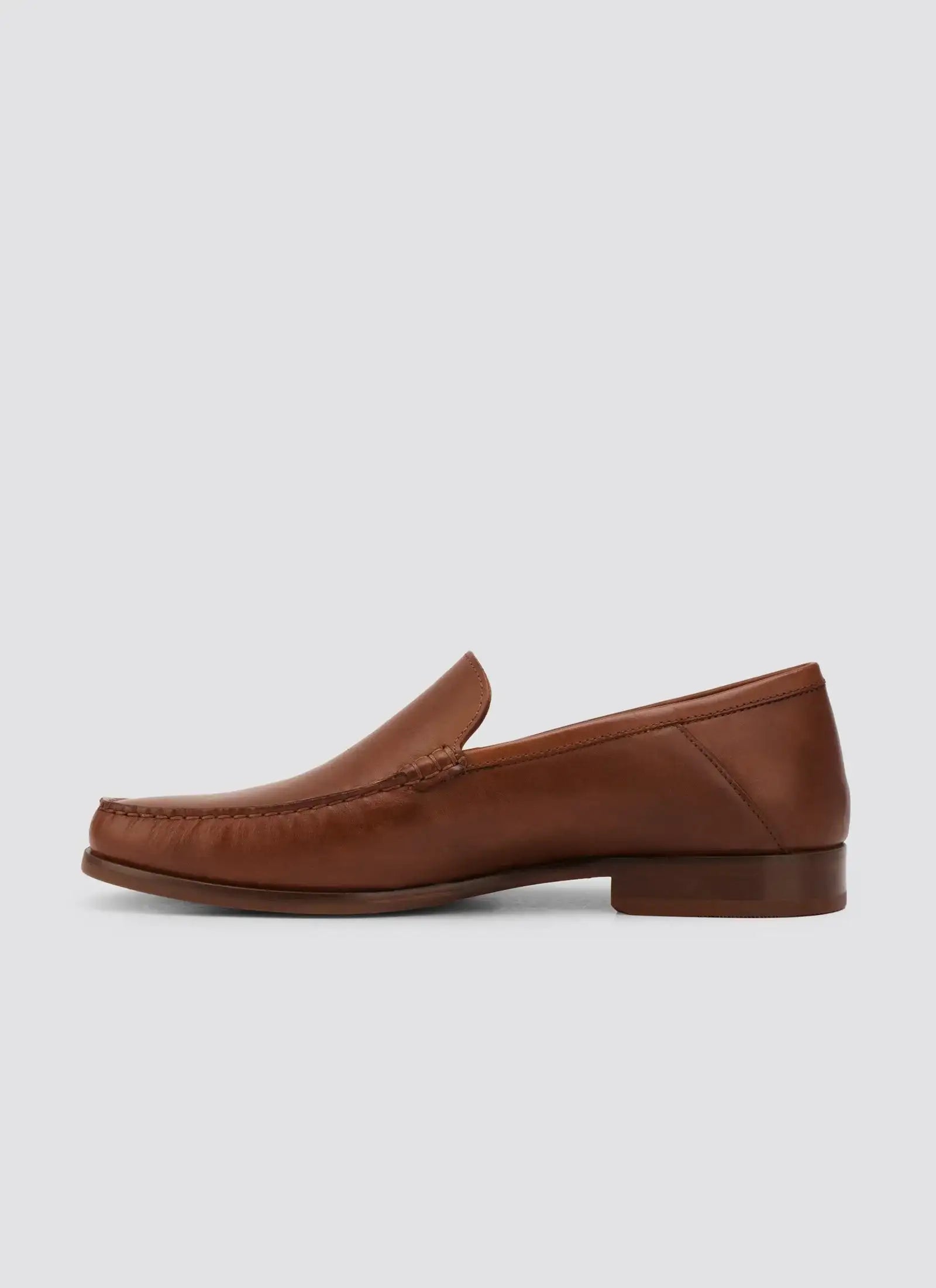 Classic brown leather loafer for men, side view, on plain background