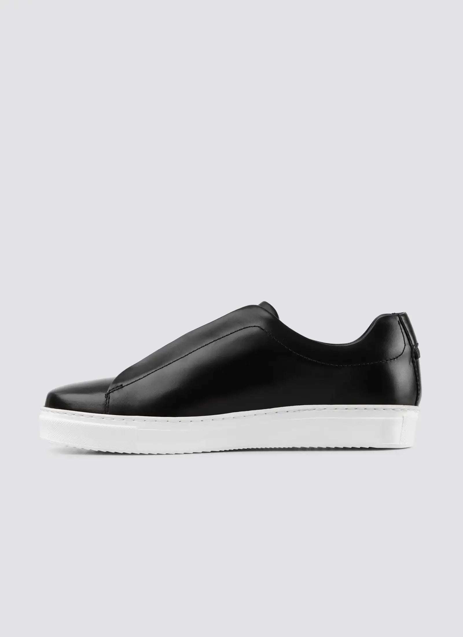 Gray sneaker with white sole on a light gray background