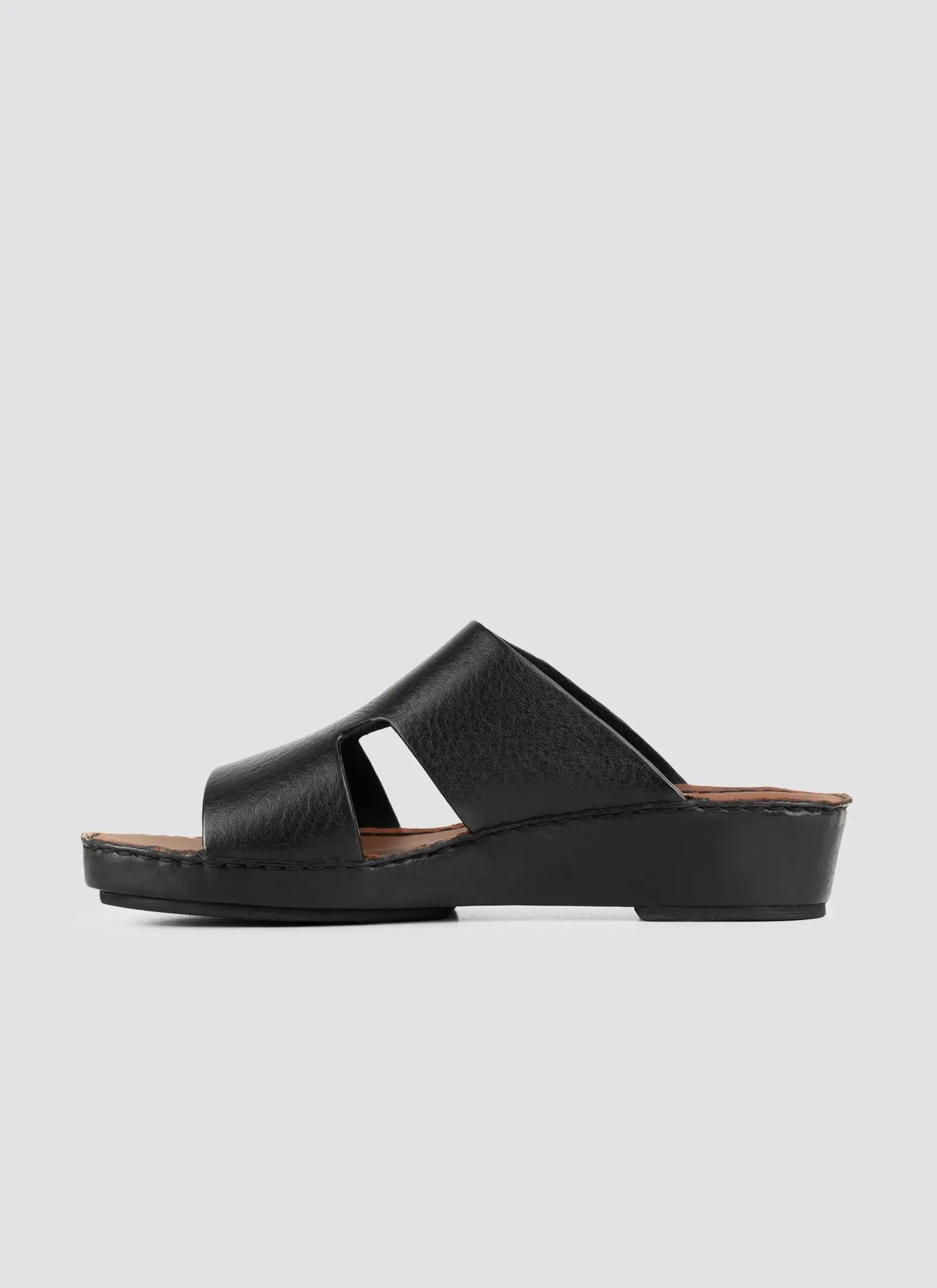 Black sandal on a light gray background