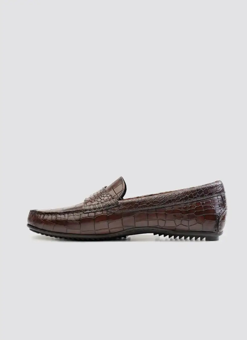 Men’s brown crocodile-texture leather loafer with rubber sole on gray background