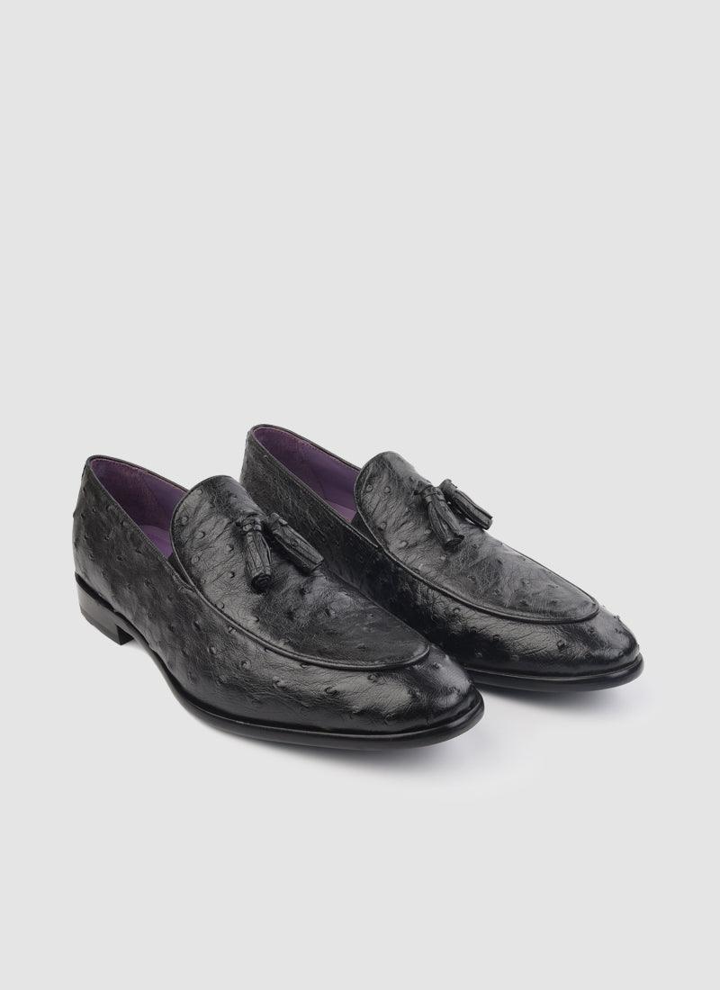 Black textured tassel loafers for men with purple inner lining on white background