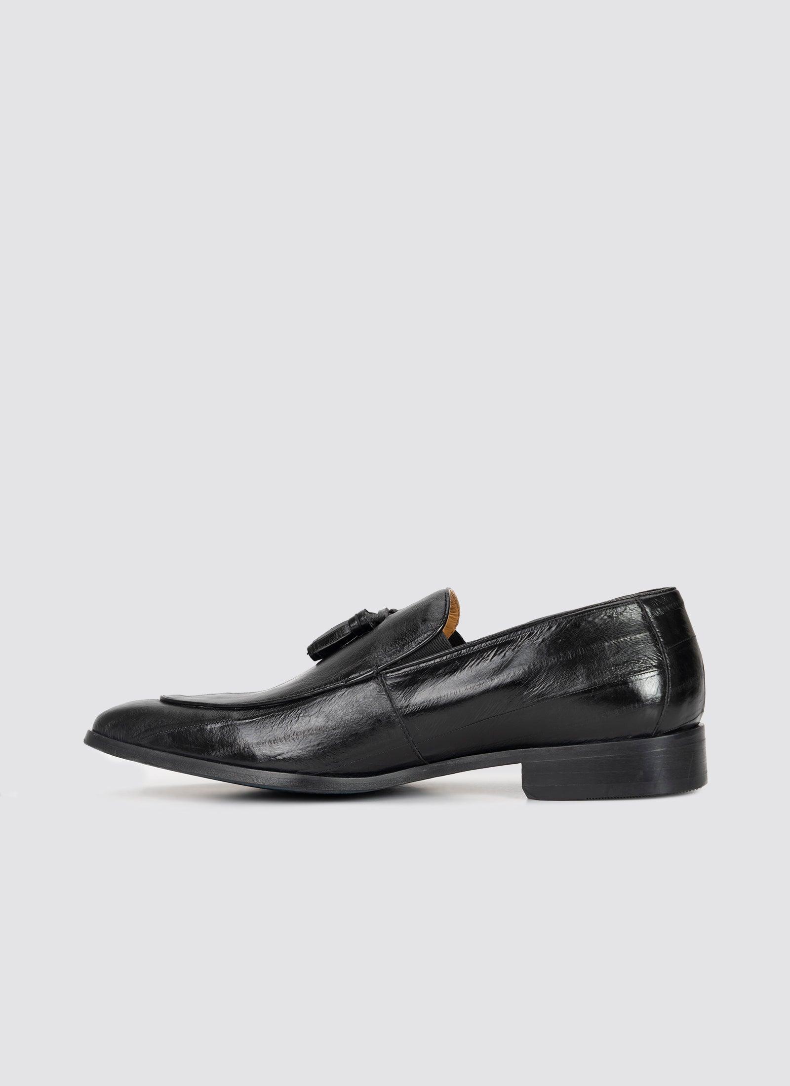 Men's black leather tassel loafer with sleek finish and low heel on white background