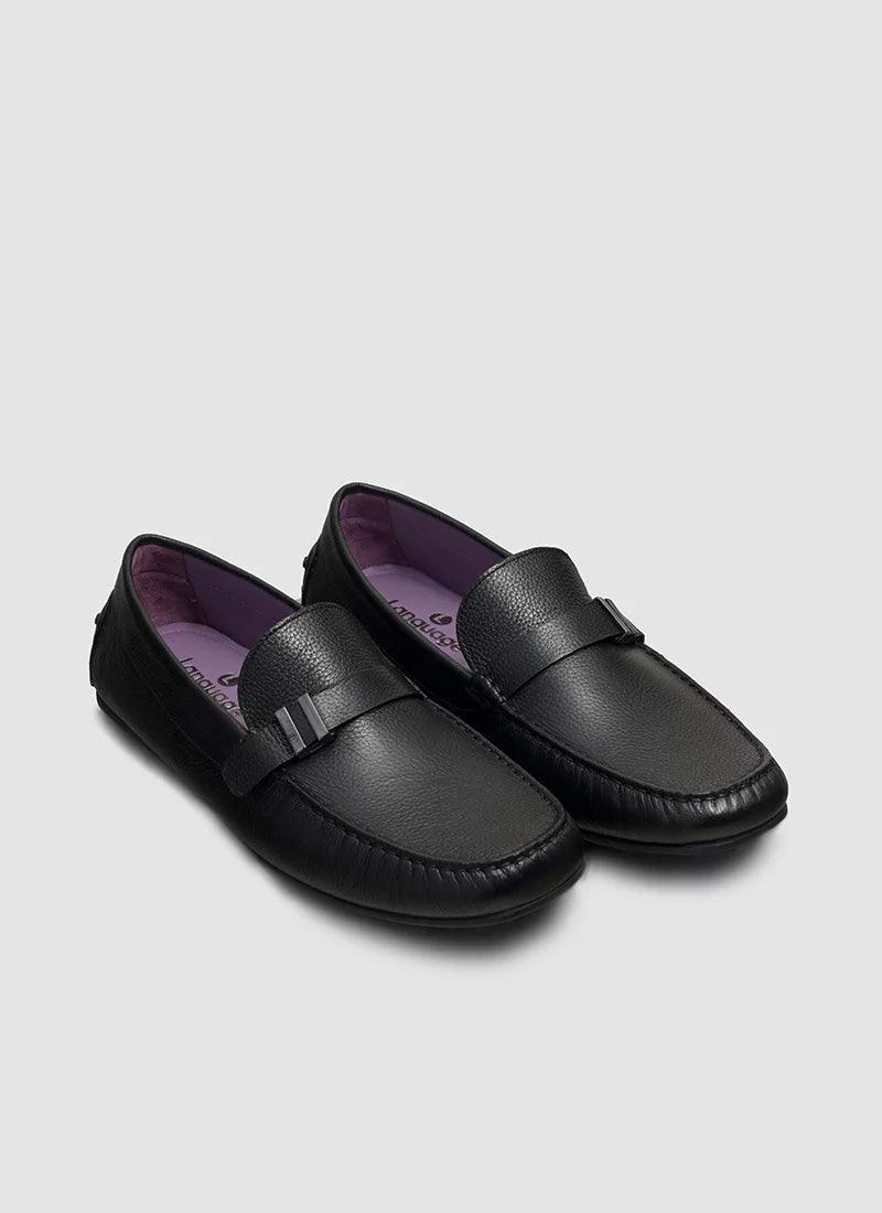 Black leather loafers for men with textured finish and purple interior on light background