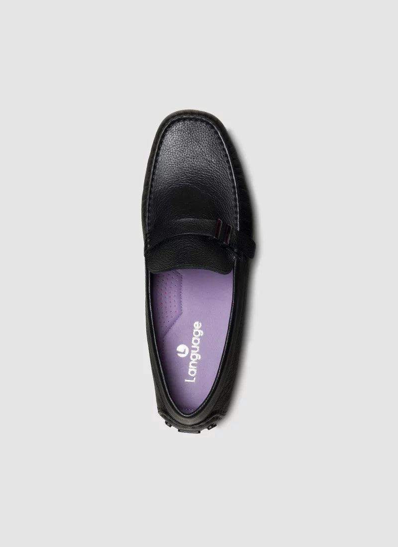Black leather loafer with textured finish and purple insole, top view on grey background