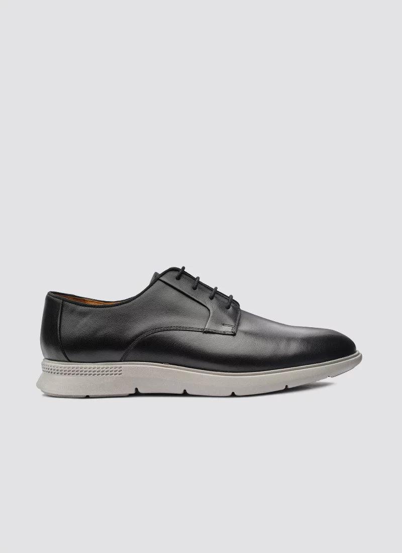 Men's black leather lace-up dress shoe with white rubber sole, side view on white background