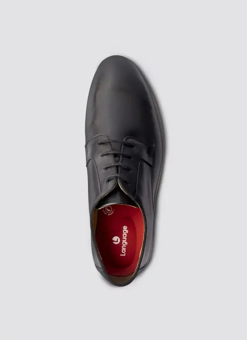 Top view of a black leather lace-up dress shoe with red insole on grey background