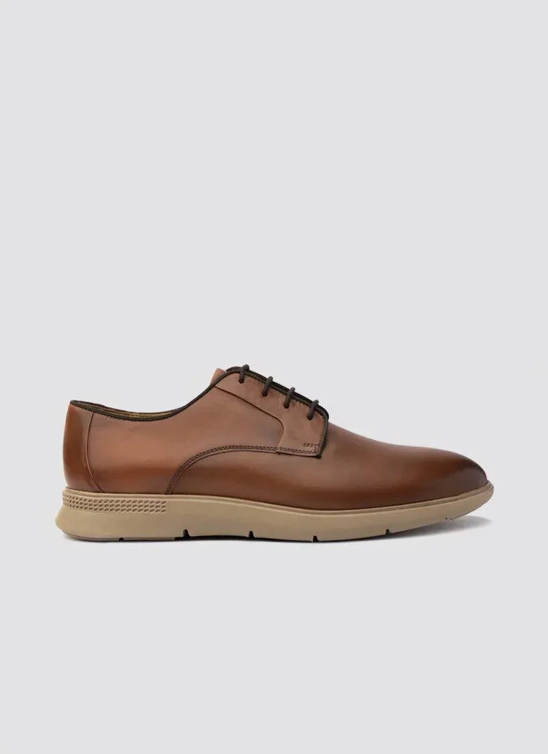 Tan leather men's lace-up dress shoe with beige rubber sole on plain background