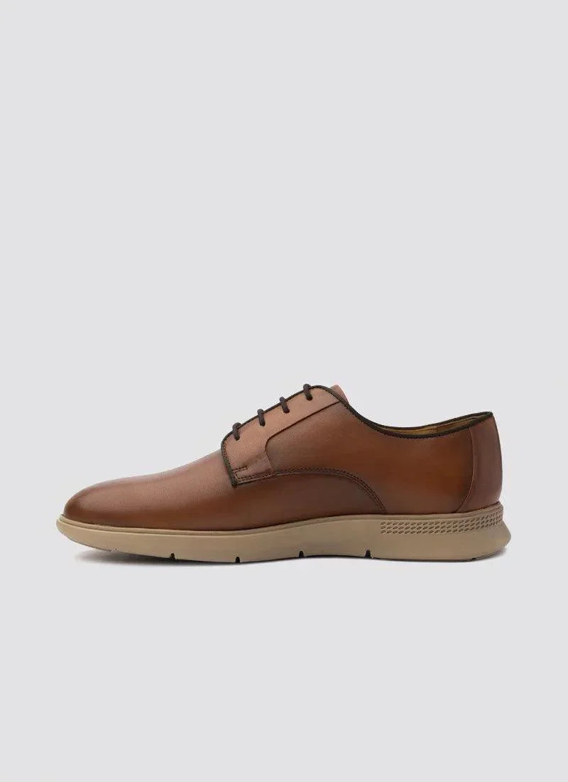 Men's tan leather lace-up dress shoe with beige sole, side view on white background