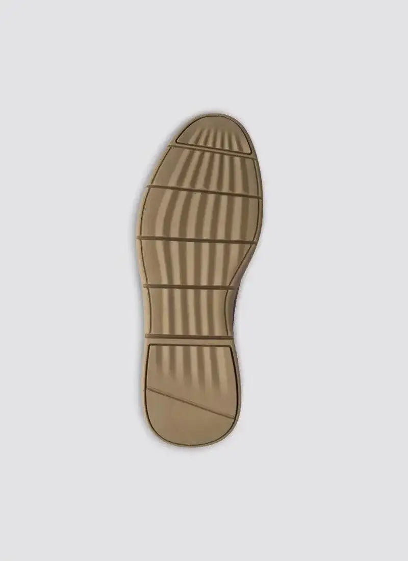 Tan rubber shoe sole with textured grip pattern on a plain background