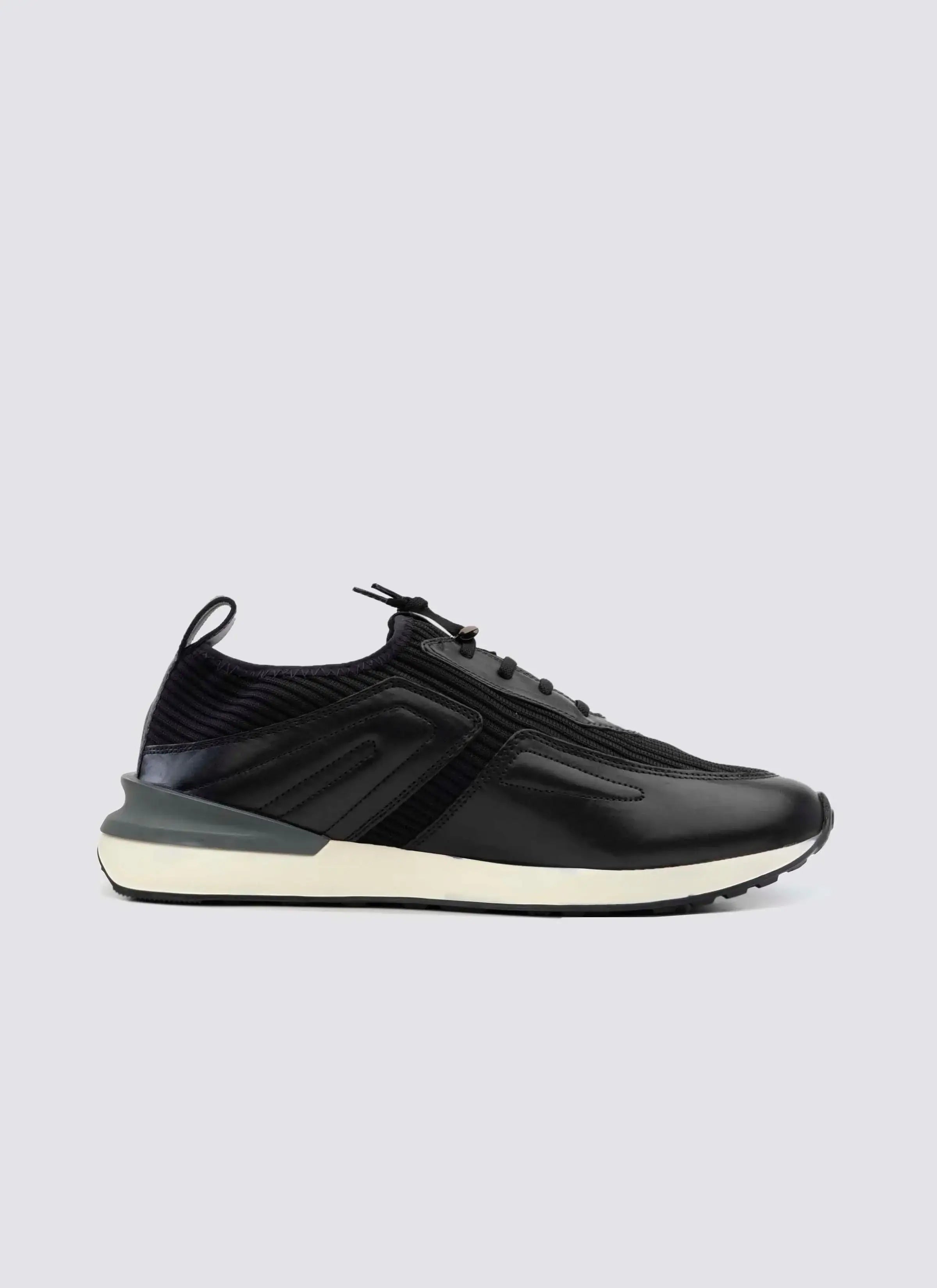 Men's black leather sneaker with white sole, side view, modern athletic footwear