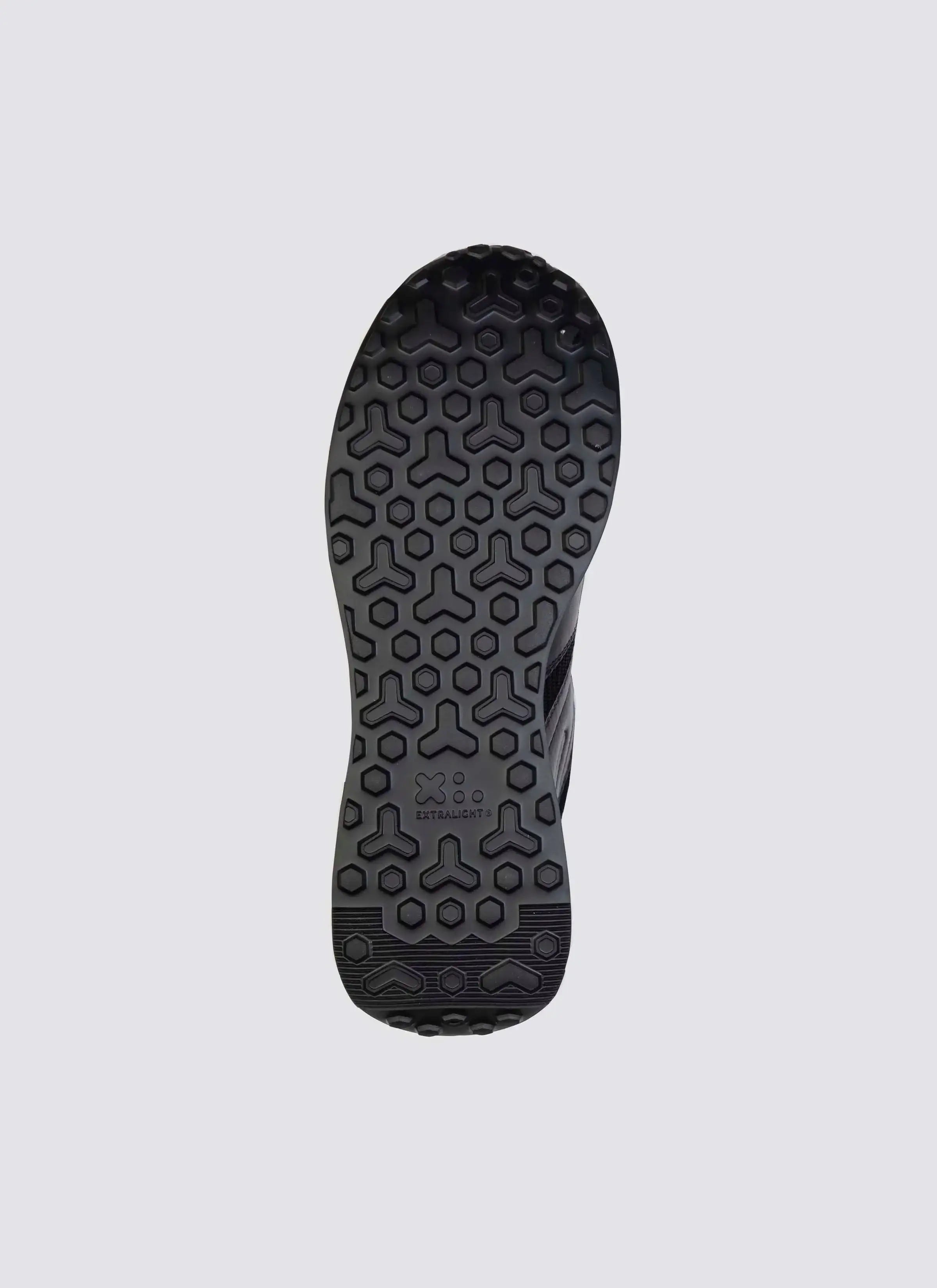 Black shoe outsole with hexagonal textured grip and Extralight branding