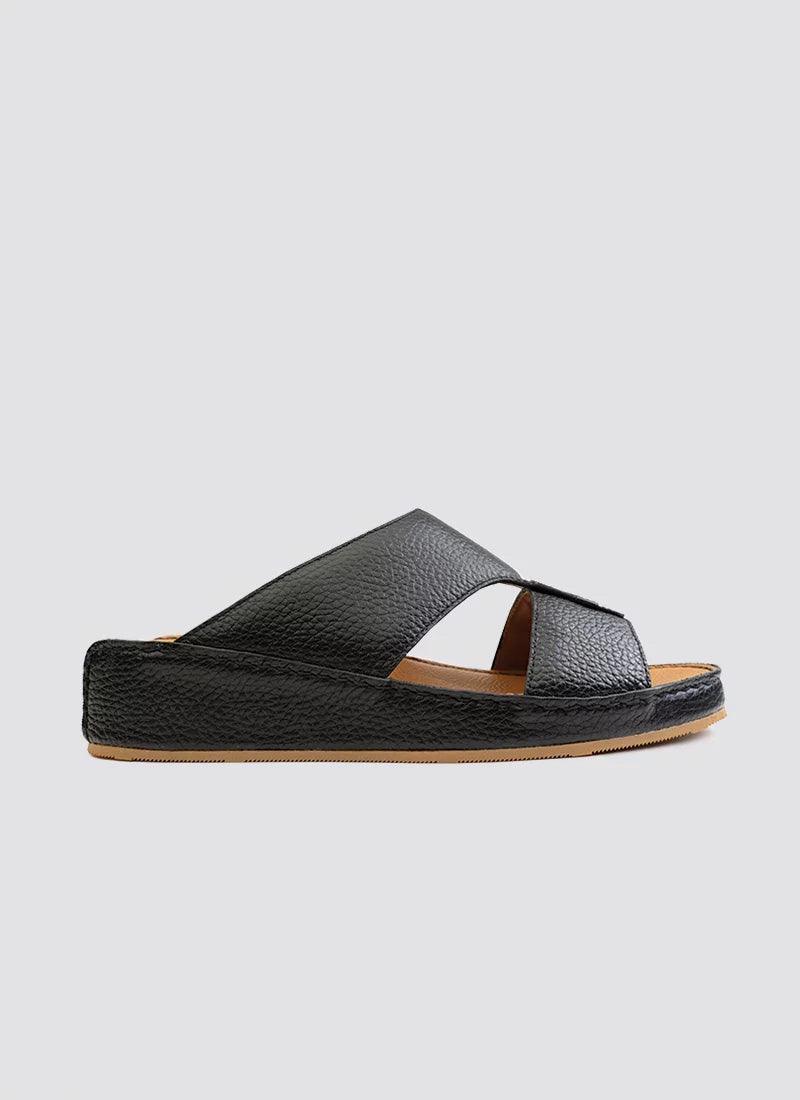 Men's black leather slide sandal with crisscross straps and textured sole on white background