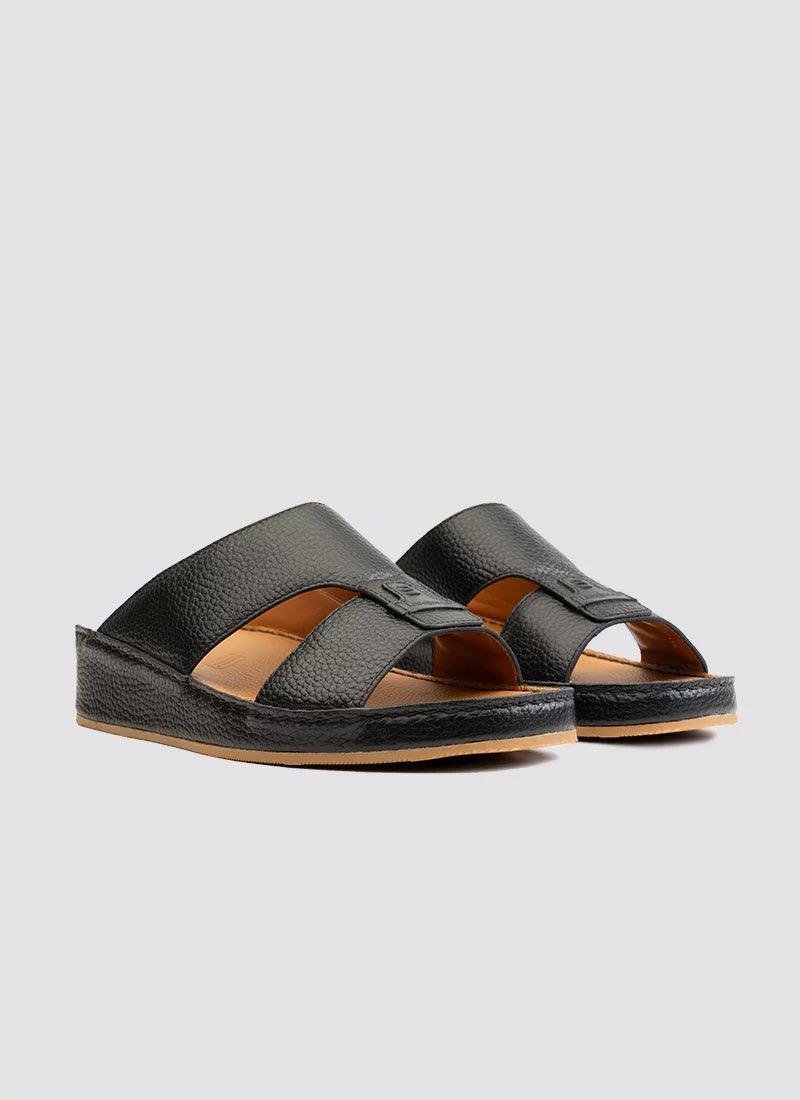 Men’s black leather open-toe sandals with cross straps and textured sole on white background