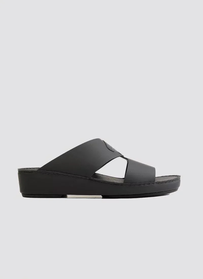 Black men's leather slide sandal with cross straps and platform sole on white background