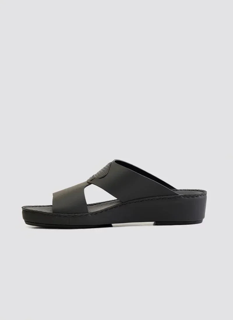 Black leather men's slide sandal with cross straps and cushioned wedge sole on white background