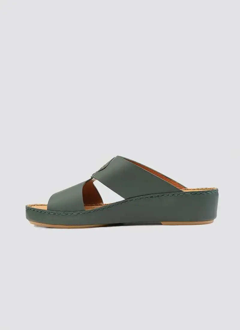 Green leather women's wedge sandal with open toe and criss-cross straps on white background