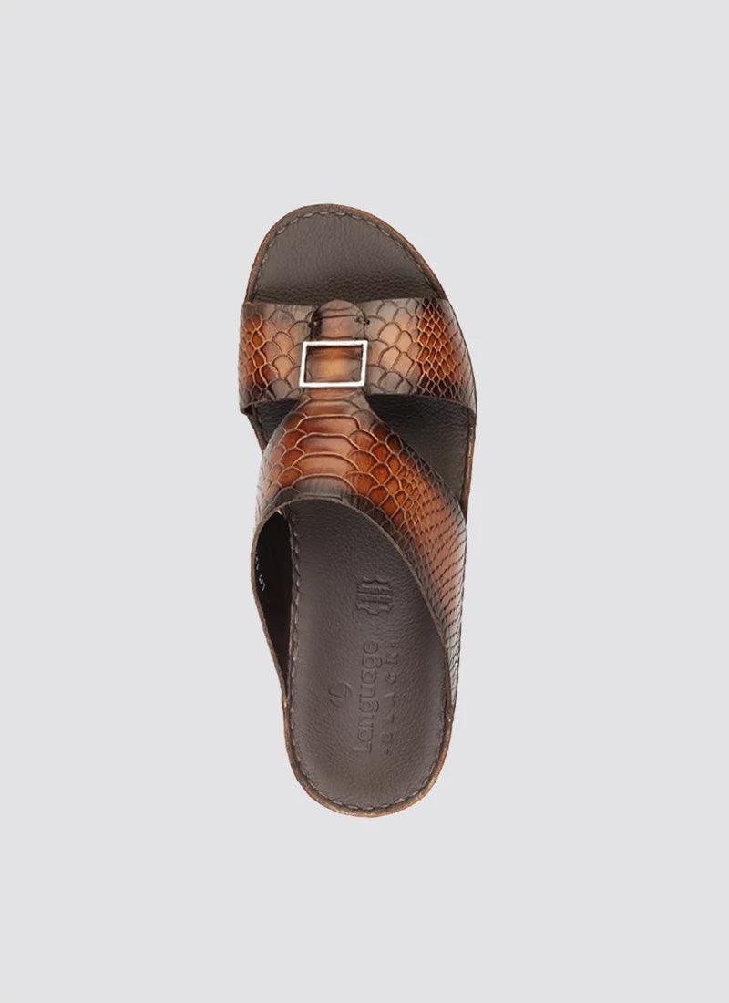 Men's brown leather slide sandal with textured pattern and metallic buckle, top view