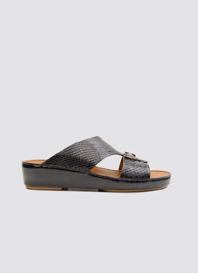 Men's black textured leather slide sandal with buckle and open toe, side view