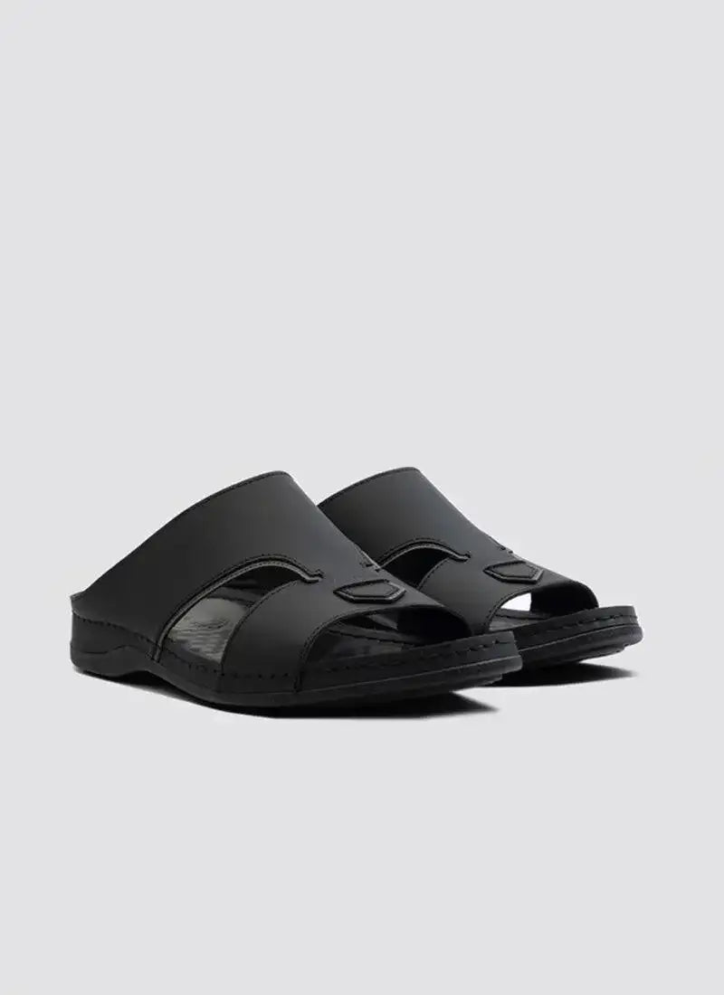 Black leather men's open-toe slides with cutout details on a plain background #color_black