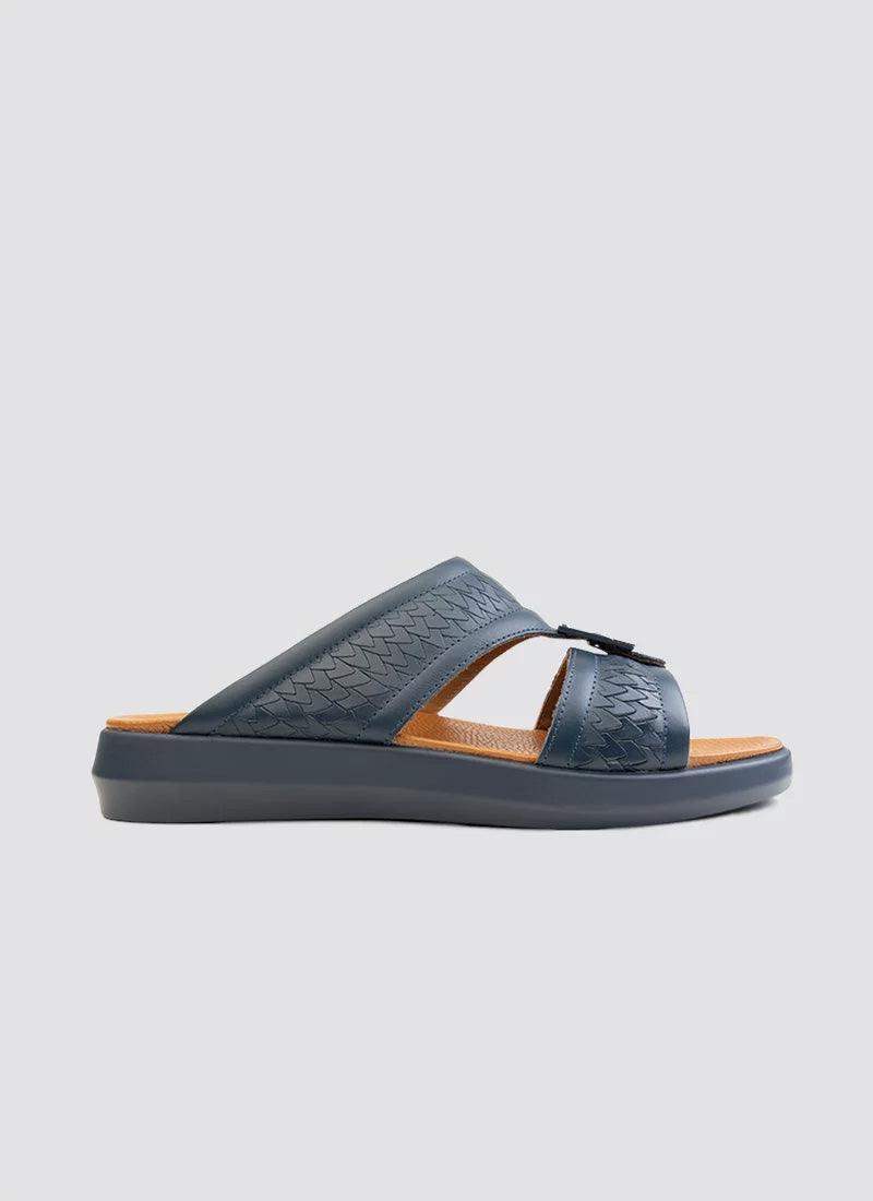 Navy blue men's slide sandal with textured leather straps and cushioned brown footbed.