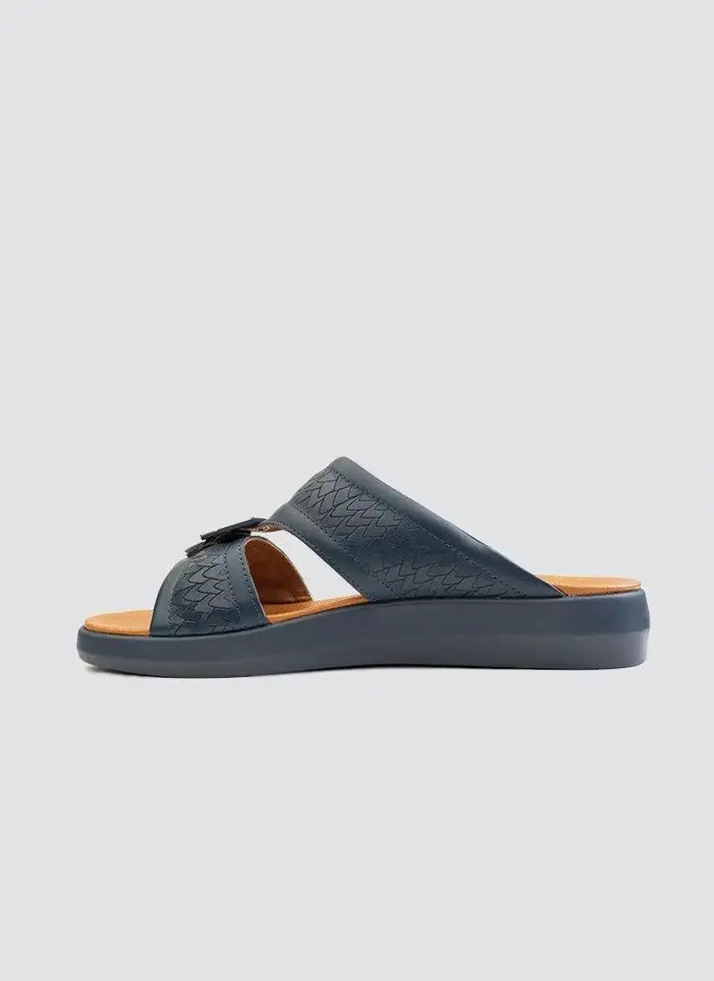 Men's navy blue slip-on sandal with textured leather straps and cushioned sole on white background