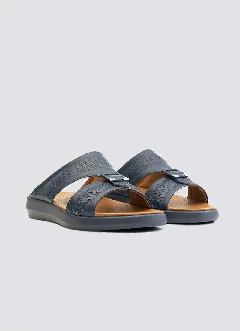 Men's navy blue slip-on sandals with textured double straps and buckle detail on light background