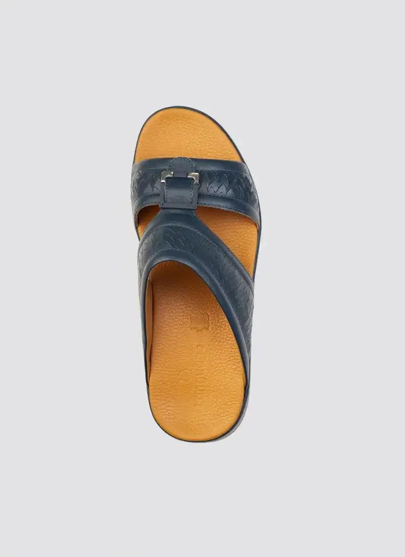 Top view of men's navy leather sandal with cross straps and buckle on tan footbed