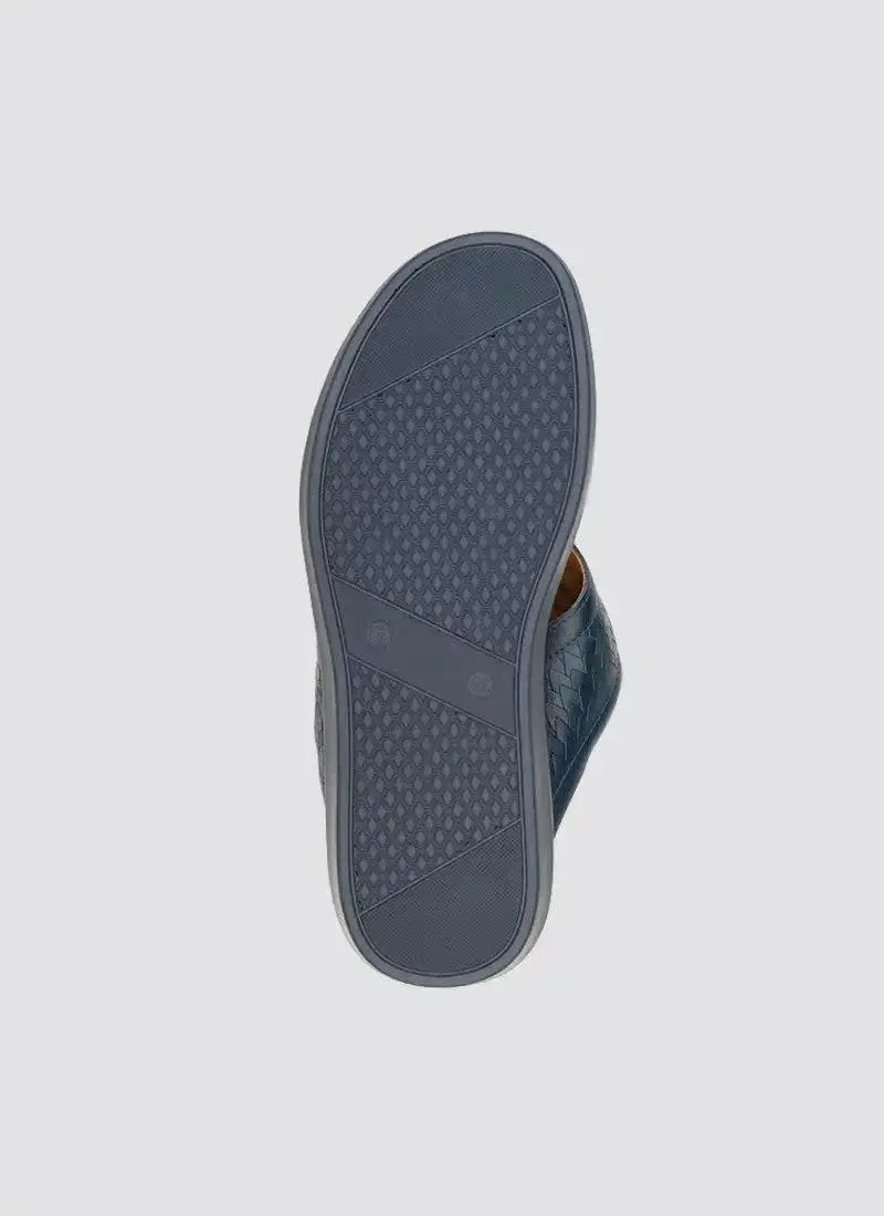 Navy blue men's shoe sole with textured rubber grip and woven leather side detailing