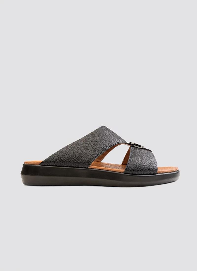 Men's black leather slide sandal with textured straps and open toe, side view on gray background
