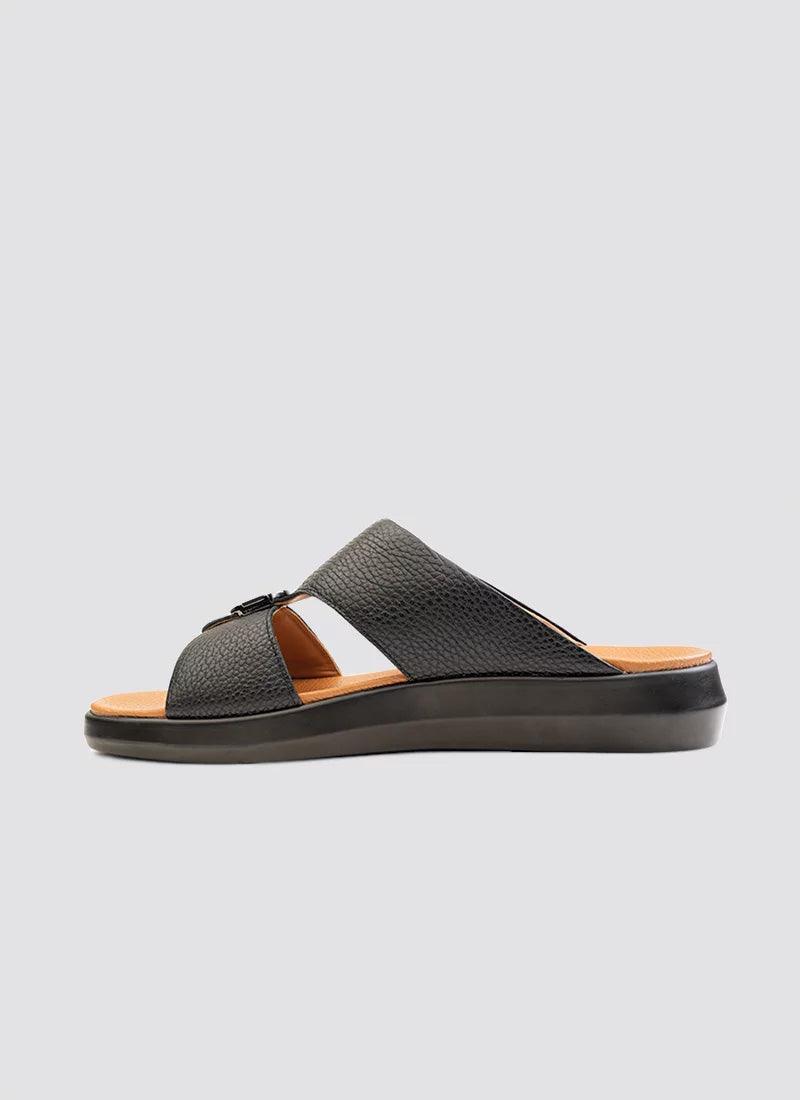 Black leather men's slide sandal with textured upper and cushioned sole on a plain background