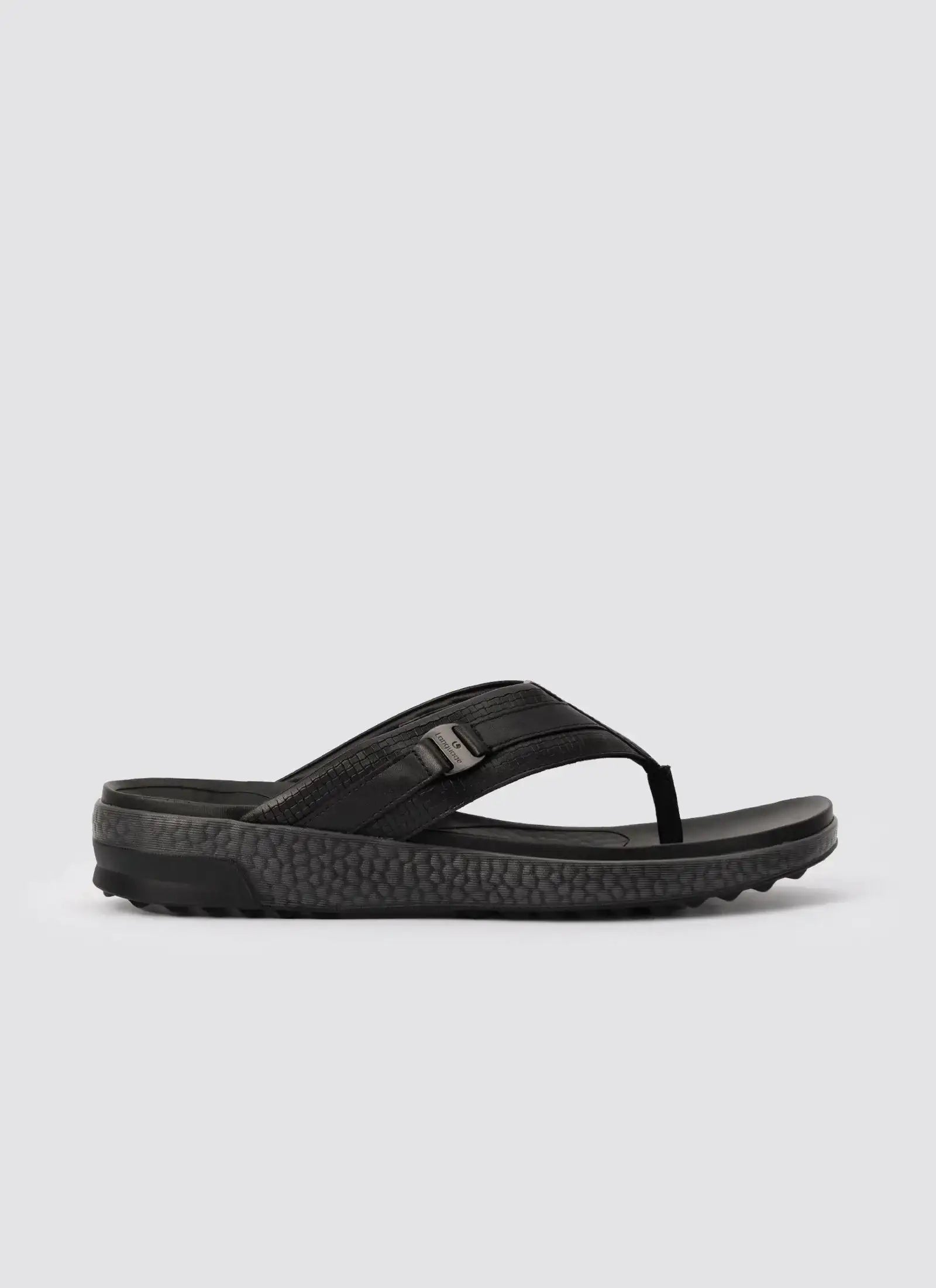 Black men's leather flip flop sandal with textured sole on white background