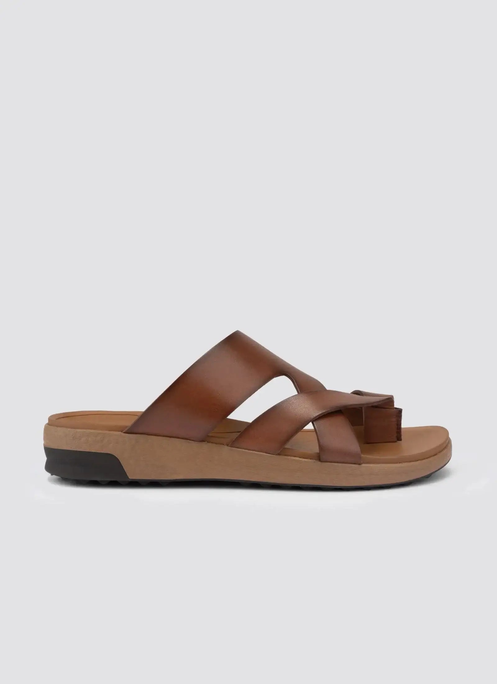 Tan brown men's leather sandal with cross straps and cushioned sole on white background