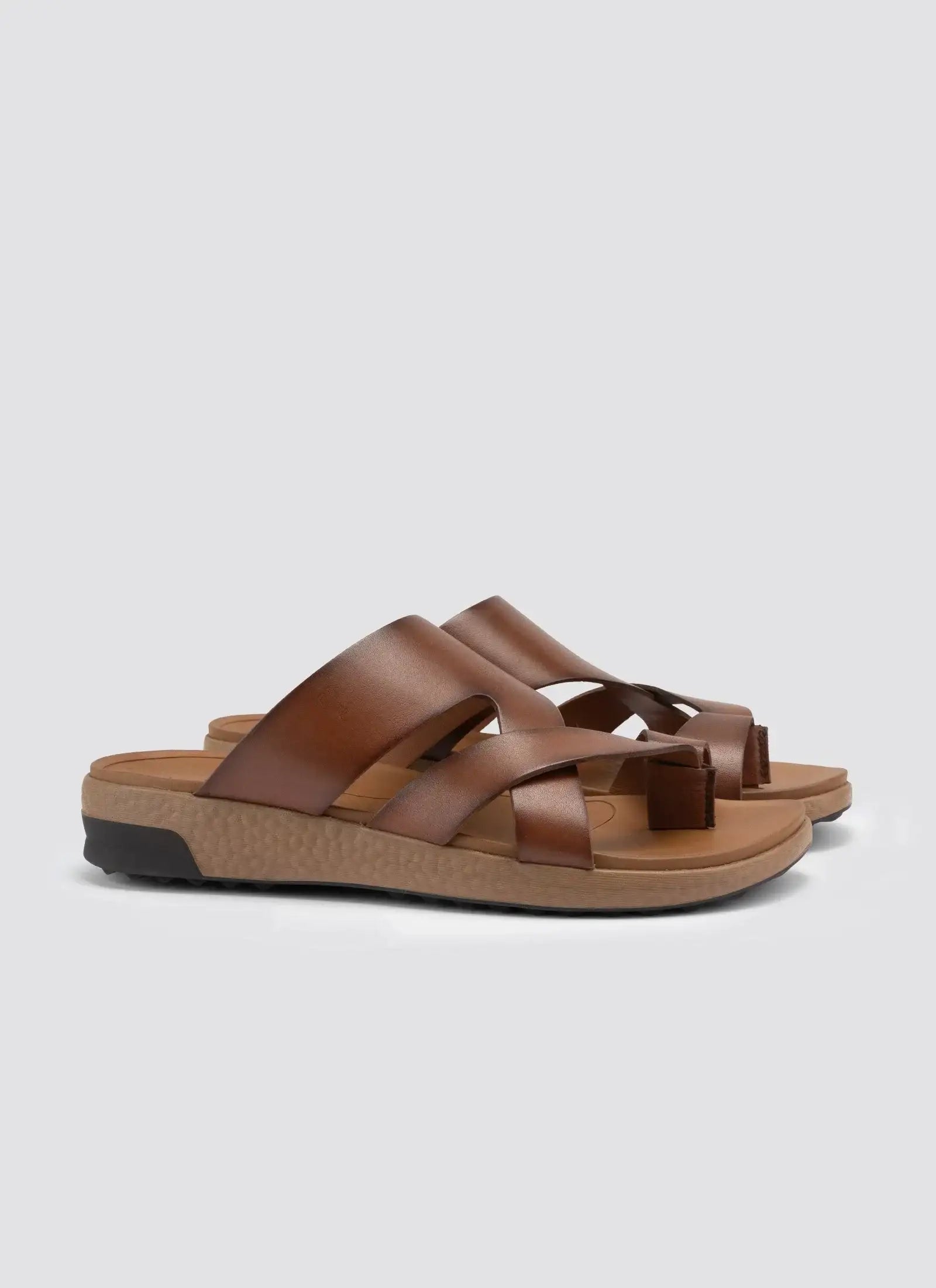 Men's tan brown leather slip-on sandals with crisscross straps and textured sole