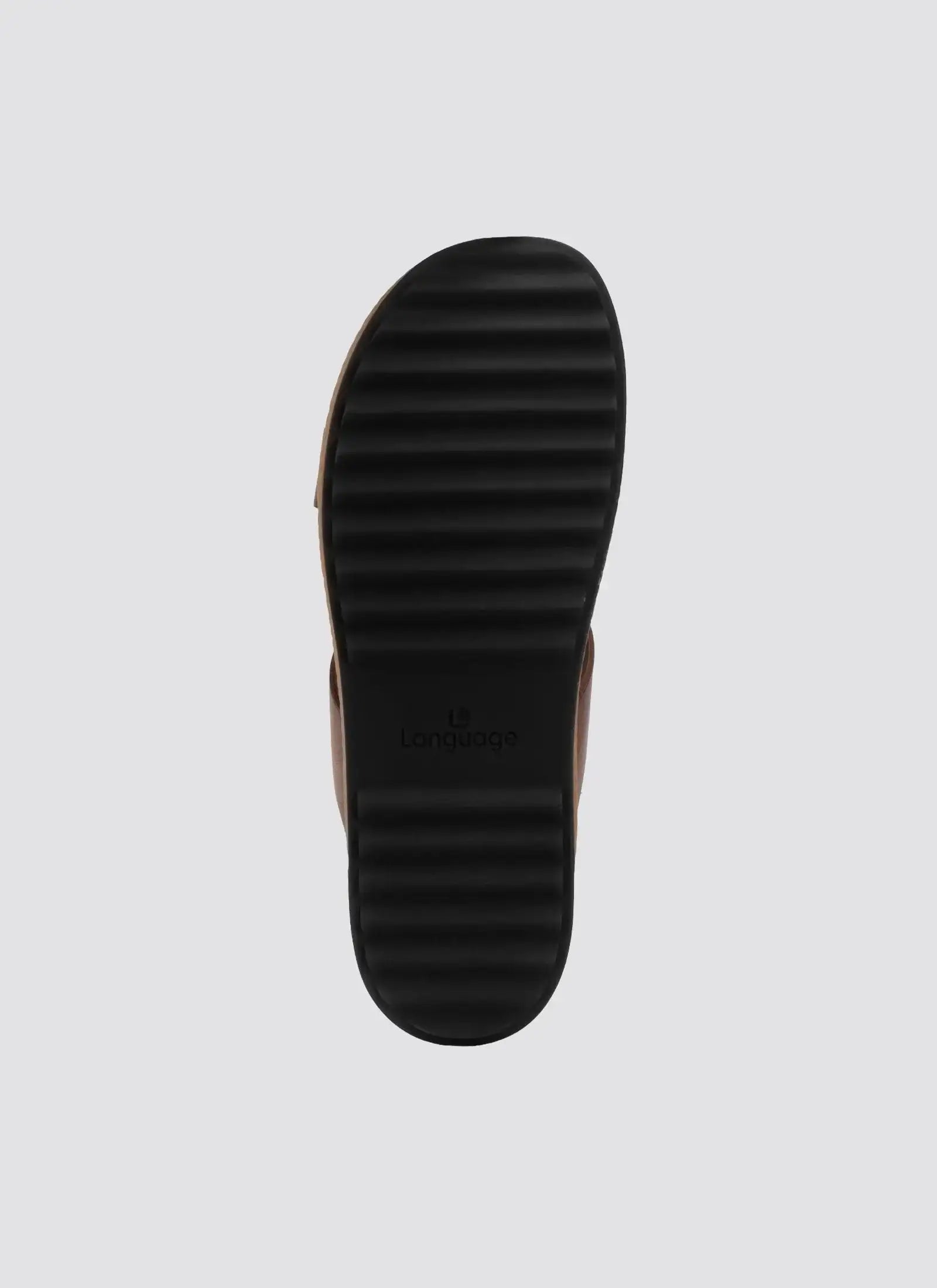 Black ribbed rubber sandal sole with visible branding on a light background