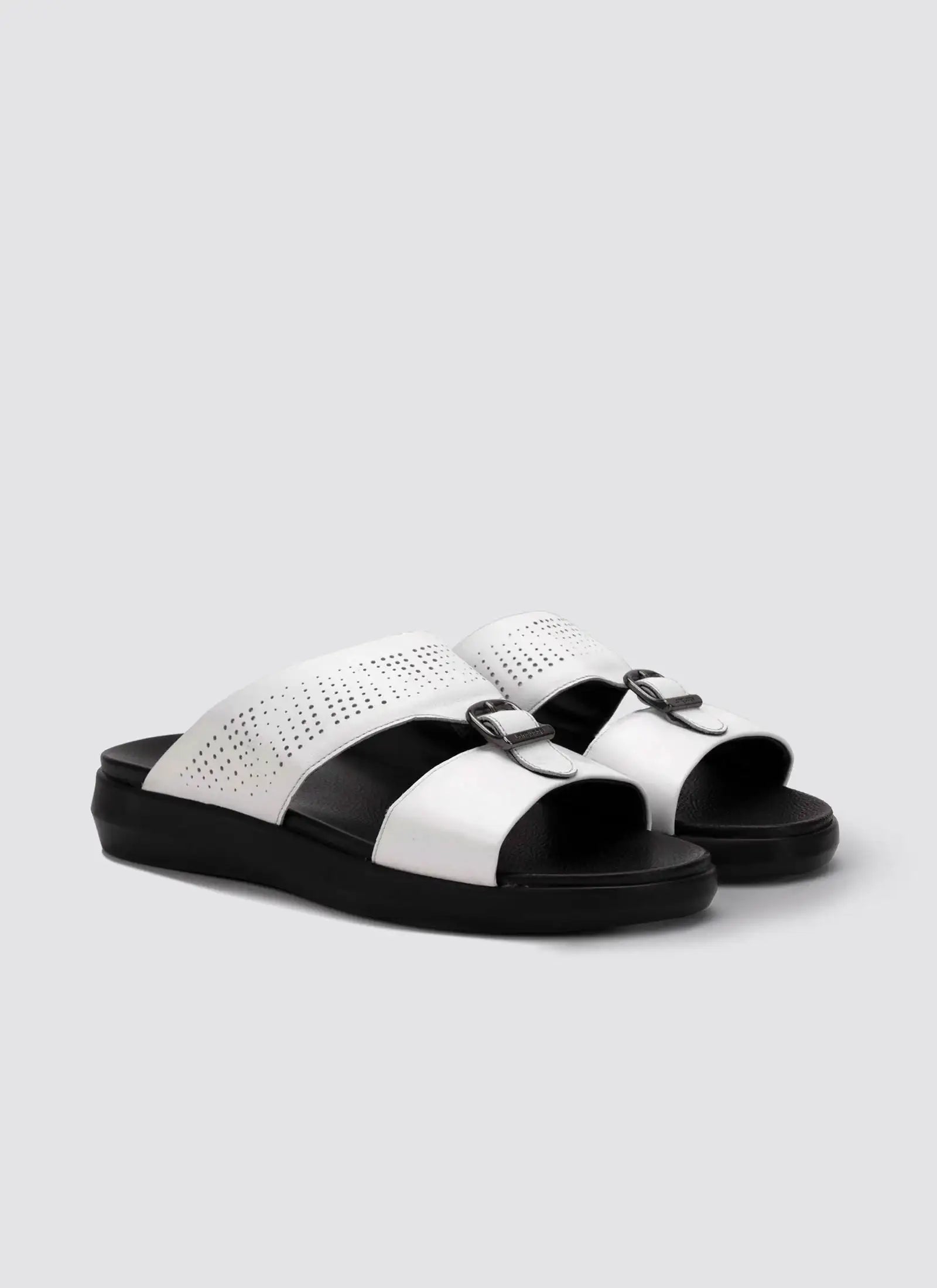Black and white sandals on a light gray background
