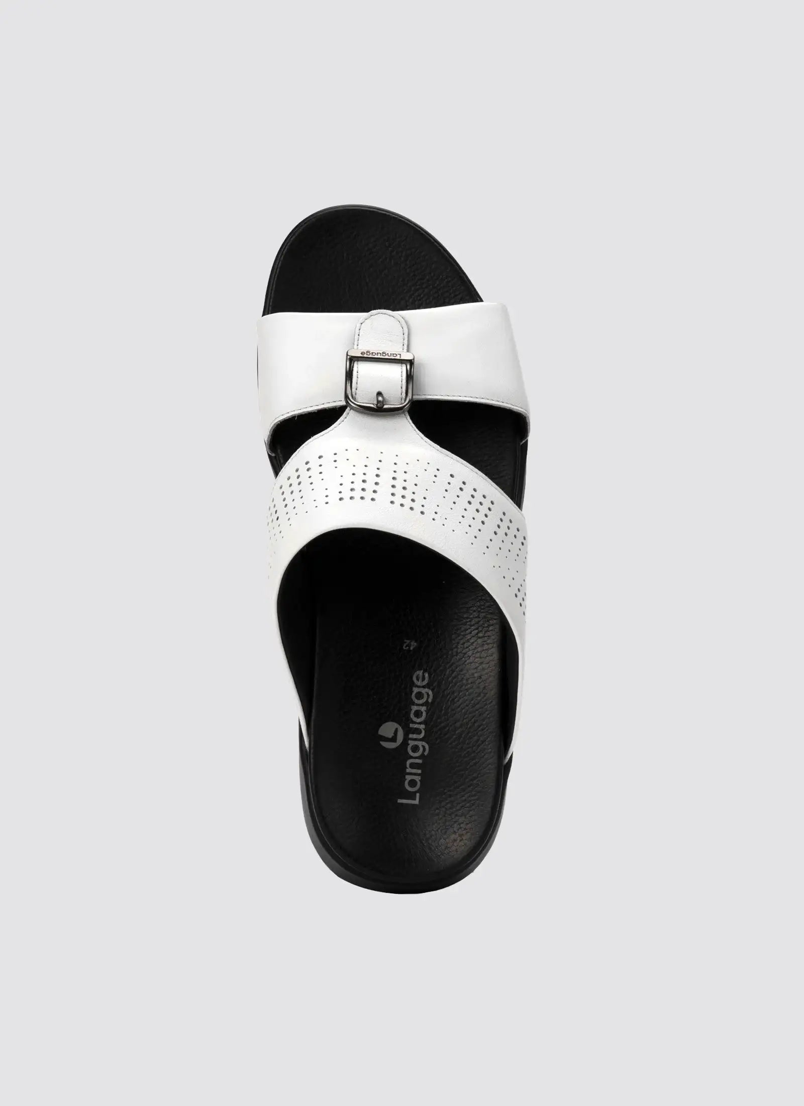 White sandal with black sole on a light gray background