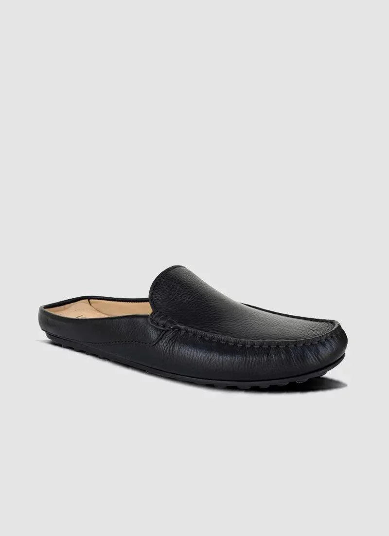 Men's black leather slip-on loafer with stitched detailing, side view on grey background