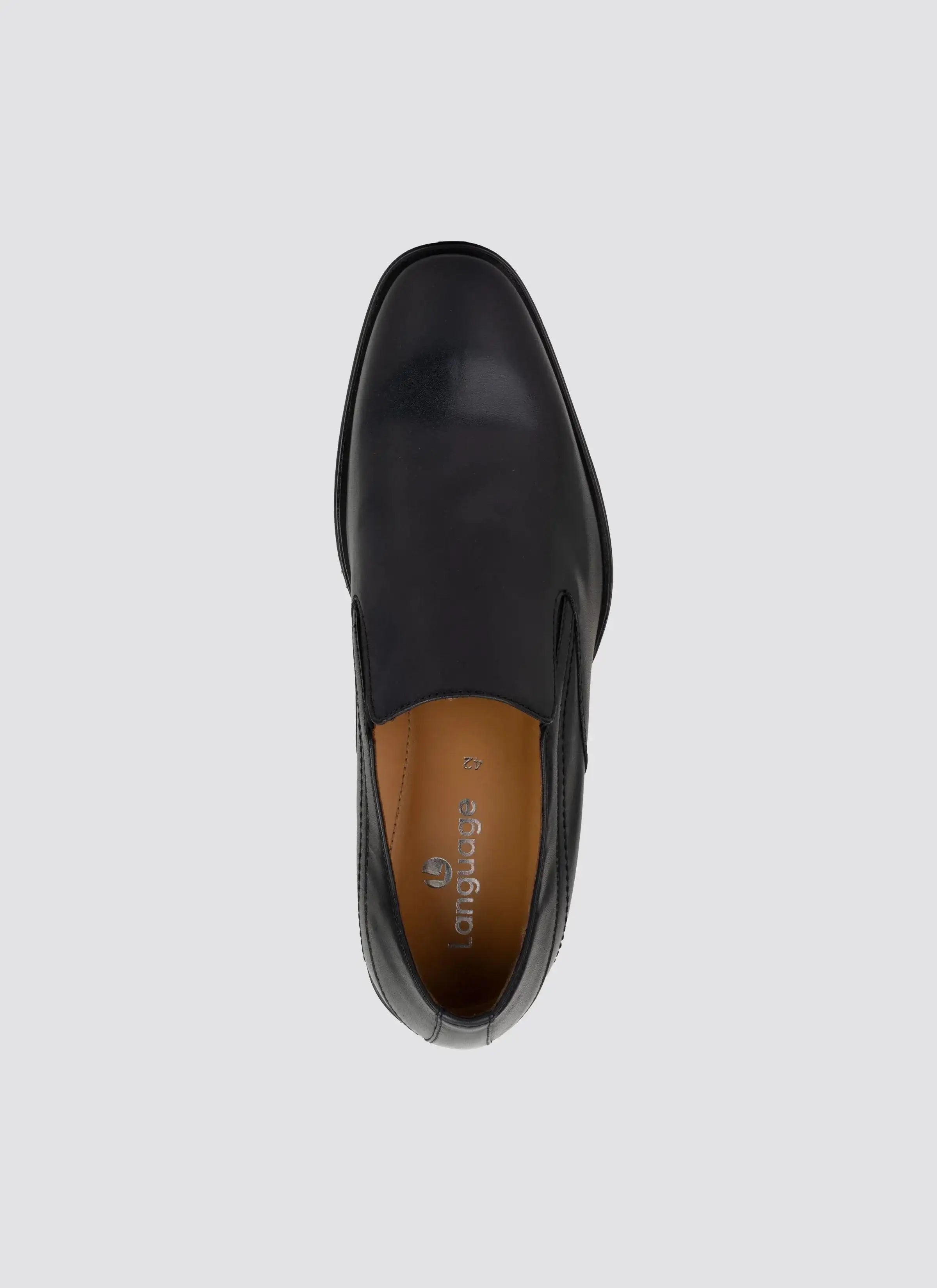 Top view of a black leather men's slip-on formal shoe on a light background