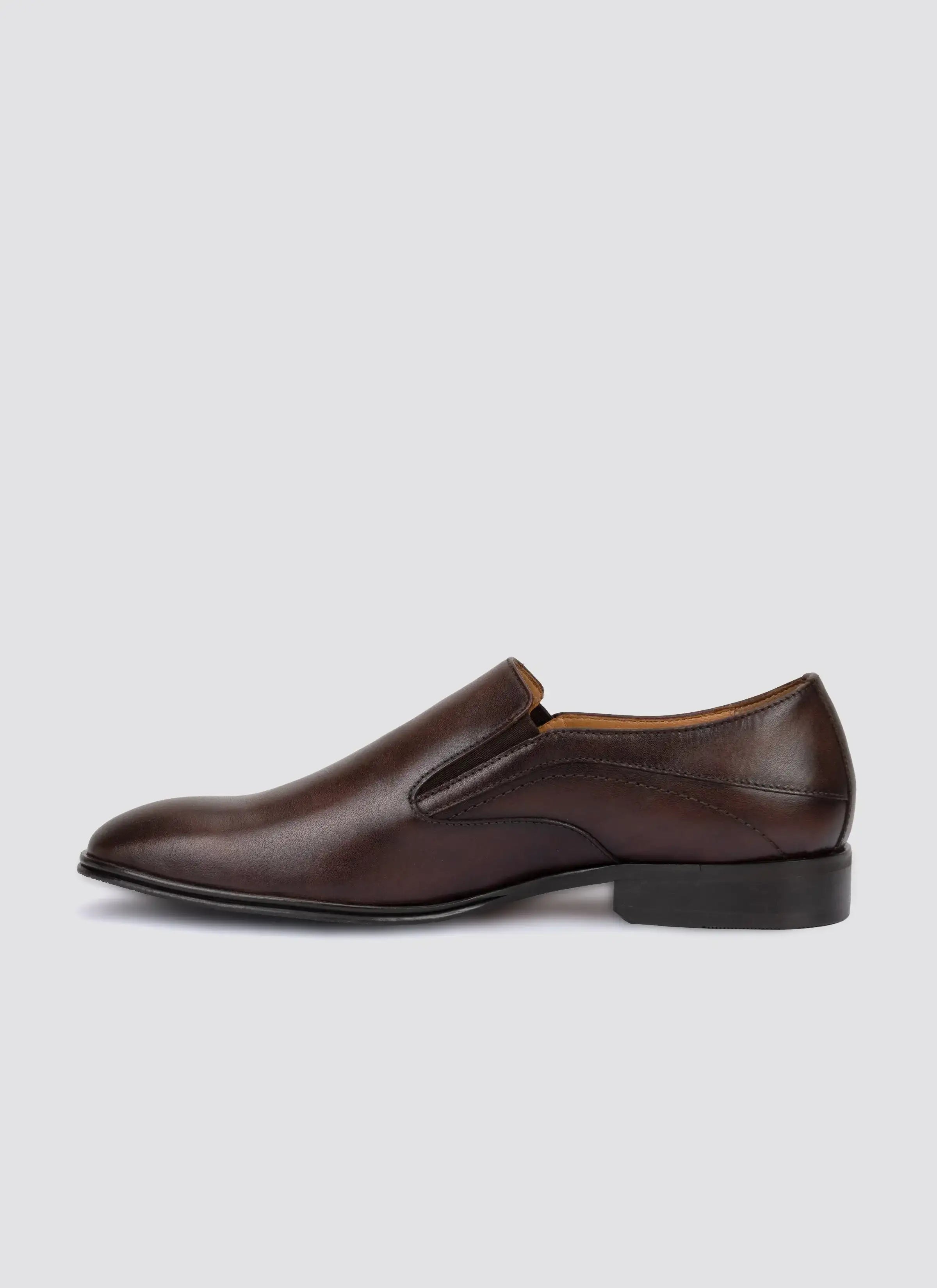 Men's brown leather slip-on dress shoe with low heel on white background